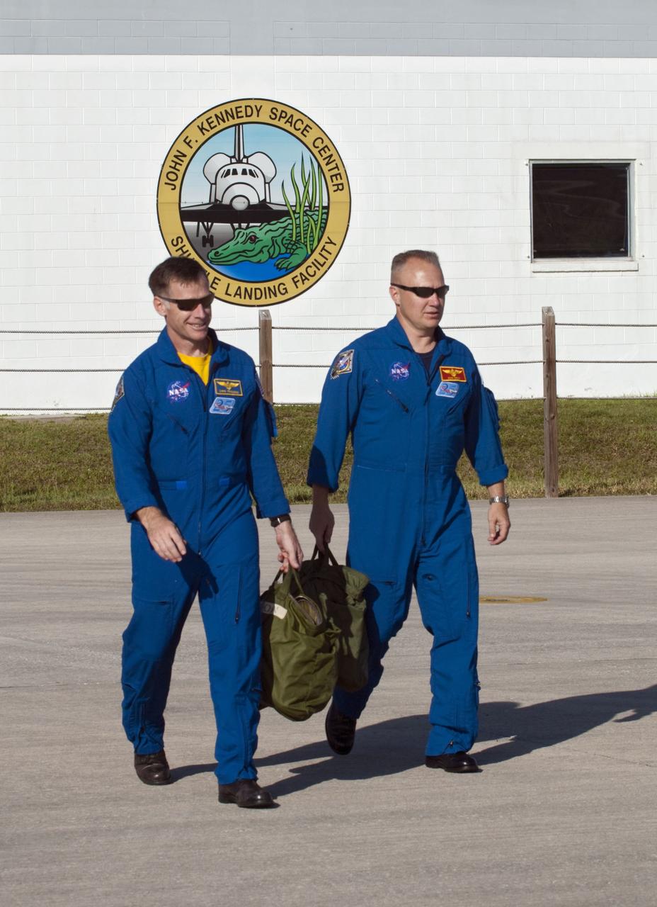CAPE CANAVERAL, Fla. -- STS-135 Commander Chris Ferguson, left, and Pilot Doug Hurley head out on the Shuttle Landing Facility at NASA's Kennedy Space Center in Florida to practice touch-and-go landings aboard two Shuttle Training Aircraft. The flight crew of four arrived aboard T-38 training jets to watch two historic milestones of NASA's Space Shuttle Program -- the final landing of shuttle Endeavour, which will bookend its STS-134 mission to the International Space Station, and the final rollout of their vehicle, space shuttle Atlantis, to Launch Pad 39A.        STS-135 will be the 33rd flight of Atlantis, the 37th shuttle mission to the space station, and the 135th and final mission of the shuttle program. For more information visit, www.nasa.gov/mission_pages/shuttle/shuttlemissions/sts135/index.html. Photo credit: NASA/Kim Shiflett