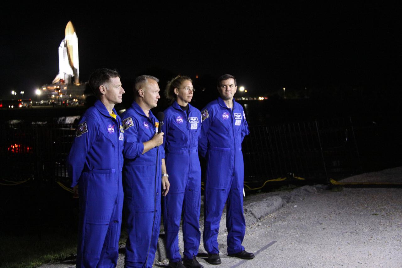 CAPE CANAVERAL, Fla. -- STS-135 Commander Chris Ferguson, left, Pilot Doug Hurley, and Mission Specialists Sandy Magnus and Rex Walheim talk to media as their vehicle, space shuttle Atlantis, makes its final journey from the Vehicle Assembly Building to Launch Pad 39A at NASA's Kennedy Space Center in Florida. First motion was at 8:42 p.m. EDT. It will take the crawler-transporter about six hours to carry the shuttle, attached to its external fuel tank and solid rocket boosters, to the seaside launch pad. The milestone move paves the way for the launch of the STS-135 mission to the International Space Station, targeted for July 8.        STS-135 will be the 33rd flight of Atlantis, the 37th shuttle mission to the space station, and the 135th and final mission of NASA's Space Shuttle Program. For more information visit, www.nasa.gov/mission_pages/shuttle/shuttlemissions/sts135/index.html. Photo credit: NASA/Troy Cryder