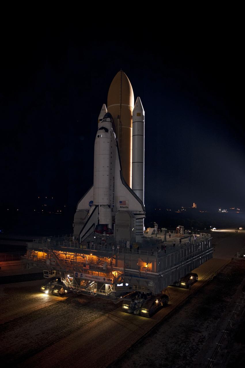 CAPE CANAVERAL, Fla. -- At a slow pace of about 1 mph, space shuttle Atlantis makes its final journey from the Vehicle Assembly Building to Launch Pad 39A at NASA's Kennedy Space Center in Florida. First motion was at 8:42 p.m. EDT. It will take the crawler-transporter about six hours to carry the shuttle, attached to its external fuel tank and solid rocket boosters, to the seaside launch pad. The milestone move paves the way for the launch of the STS-135 mission to the International Space Station, targeted for July 8.      STS-135 will be the 33rd flight of Atlantis, the 37th shuttle mission to the space station, and the 135th and final mission of NASA's Space Shuttle Program. For more information visit, www.nasa.gov/mission_pages/shuttle/shuttlemissions/sts135/index.html. Photo credit: NASA/Kim Shiflett
