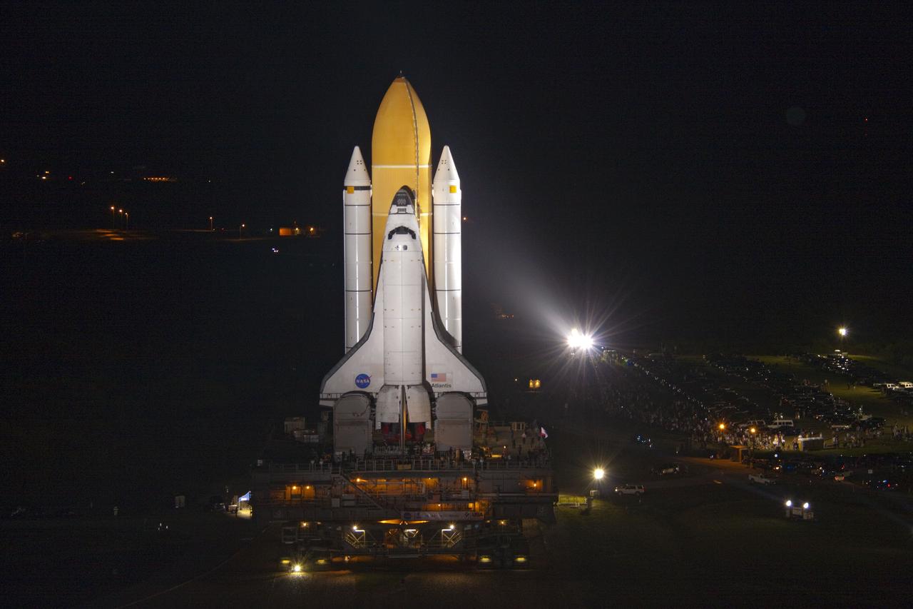 CAPE CANAVERAL, Fla. -- Bright xenon lights usher space shuttle Atlantis down a 3.4-mile stretch of river rocks as the vehicle embarks on its historic final journey from the Vehicle Assembly Building to Launch Pad 39A at NASA's Kennedy Space Center in Florida. "Rollout," as it's called, began at 8:42 p.m. EDT. It will take the crawler-transporter about six hours to carry Atlantis, attached to its external fuel tank and solid rocket boosters atop a mobile launcher platform, to the seaside launch pad. The milestone move paves the way for the launch of the STS-135 mission to the International Space Station, targeted for July 8.      STS-135 will be the 33rd flight of Atlantis, the 37th shuttle mission to the space station, and the 135th and final mission of NASA's Space Shuttle Program. For more information visit, www.nasa.gov/mission_pages/shuttle/shuttlemissions/sts135/index.html. Photo credit: NASA/Jack Pfaller