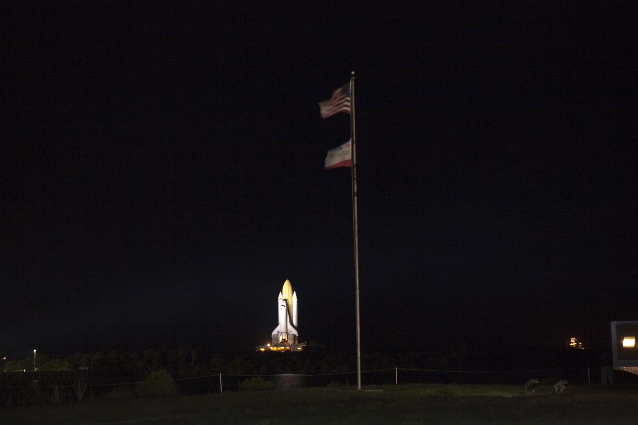 CAPE CANAVERAL, Fla. -- Space shuttle Atlantis makes its historic final journey from the Vehicle Assembly Building to Launch Pad 39A at NASA's Kennedy Space Center in Florida while the flags of America and shuttle Endeavour wave proudly in a light breeze. First motion was at 8:42 p.m. EDT. The milestone move, known as "rollout," paves the way for the launch of the STS-135 mission to the International Space Station, targeted for July 8. Atlantis is slated to arrive at its seaside launch pad about an hour after Endeavour lands on Kennedy's Shuttle Landing Facility runway for the last time, bringing an end to the STS-134 mission.      STS-135 will be the 33rd flight of Atlantis, the 37th shuttle mission to the space station, and the 135th and final mission of NASA's Space Shuttle Program. For more information visit, www.nasa.gov/mission_pages/shuttle/shuttlemissions/sts135/index.html. Photo credit: NASA/Gianni Woods