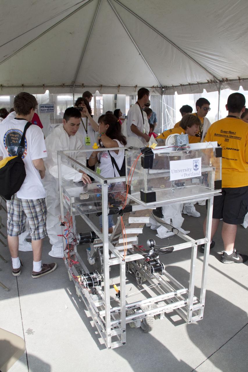 CAPE CANAVERAL, Fla. -- University students make final preparations for NASA's second annual Lunabotics Mining Competition held at the Kennedy Space Center Visitor Complex in Florida.        Thirty-six teams of undergraduate and graduate students from the United States, Bangladesh, Canada, Colombia and India will participate in NASA's Lunabotics Mining Competition May 26 - 28 at the agency's Kennedy Space Center in Florida. The competition is designed to engage and retain students in science, technology, engineering and mathematics (STEM). Teams will maneuver their remote controlled or autonomous excavators, called lunabots, in about 60 tons of ultra-fine simulated lunar soil, called BP-1. The competition is an Exploration Systems Mission Directorate project managed by Kennedy's Education Division. The event also provides a competitive environment that could result in innovative ideas and solutions for NASA's future excavation of the moon. Photo credit: NASA/Jack Pfaller