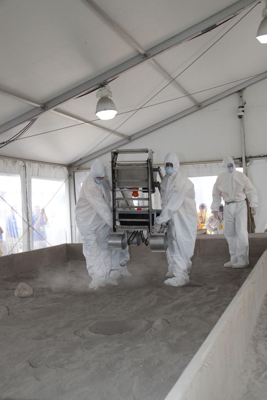 CAPE CANAVERAL, Fla. -- Inside the "Lunarena" at the Kennedy Space Center Visitor Complex in Florida, university students maneuver their remote controlled or autonomous excavators, called lunabots, in a "sand box" of ultra-fine simulated lunar soil during NASA's second annual Lunabotics Mining Competition.    Thirty-six teams of undergraduate and graduate students from the United States, Bangladesh, Canada, Colombia and India will participate in NASA's Lunabotics Mining Competition May 26 - 28 at the agency's Kennedy Space Center in Florida. The competition is designed to engage and retain students in science, technology, engineering and mathematics (STEM). Teams will maneuver their remote controlled or autonomous excavators, called lunabots, in about 60 tons of ultra-fine simulated lunar soil, called BP-1. The competition is an Exploration Systems Mission Directorate project managed by Kennedy's Education Division. The event also provides a competitive environment that could result in innovative ideas and solutions for NASA's future excavation of the moon. Photo credit: NASA/Jack Pfaller