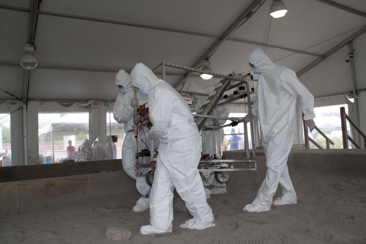 CAPE CANAVERAL, Fla. -- Inside the "Lunarena" at the Kennedy Space Center Visitor Complex in Florida, university students maneuver their remote controlled or autonomous excavators, called lunabots, in a "sand box" of ultra-fine simulated lunar soil during NASA's second annual Lunabotics Mining Competition.    Thirty-six teams of undergraduate and graduate students from the United States, Bangladesh, Canada, Colombia and India will participate in NASA's Lunabotics Mining Competition May 26 - 28 at the agency's Kennedy Space Center in Florida. The competition is designed to engage and retain students in science, technology, engineering and mathematics (STEM). Teams will maneuver their remote controlled or autonomous excavators, called lunabots, in about 60 tons of ultra-fine simulated lunar soil, called BP-1. The competition is an Exploration Systems Mission Directorate project managed by Kennedy's Education Division. The event also provides a competitive environment that could result in innovative ideas and solutions for NASA's future excavation of the moon. Photo credit: NASA/Jack Pfaller
