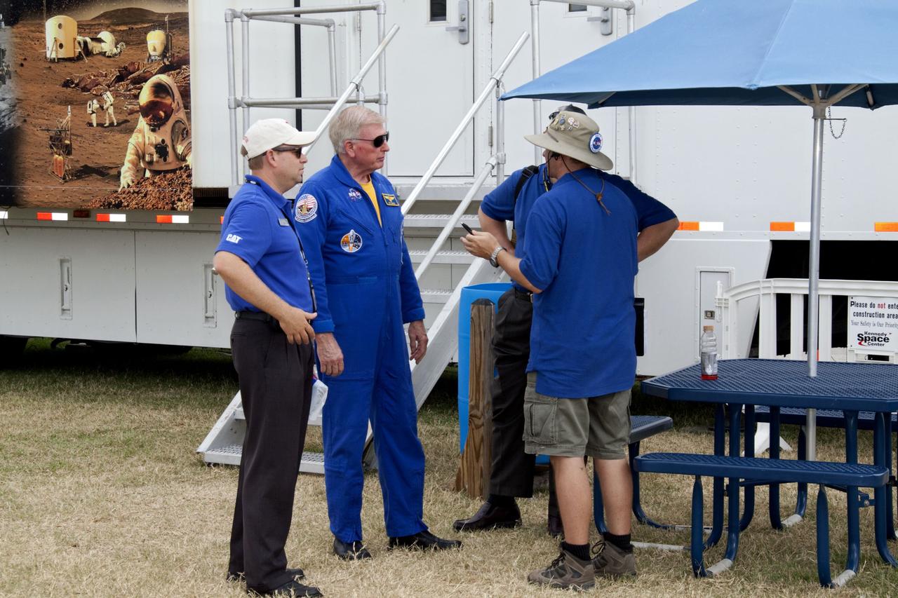 CAPE CANAVERAL, Fla. -- Outside the "Lunarena" at the Kennedy Space Center Visitor Complex in Florida, NASA astronaut John McBride (center) discusses the day's events with event leaders during NASA's second annual Lunabotics Mining Competition. Thirty-six teams of undergraduate and graduate students from the United States, Bangladesh, Canada, Colombia and India will participate in NASA's Lunabotics Mining Competition May 26 - 28 at the agency's Kennedy Space Center in Florida. The competition is designed to engage and retain students in science, technology, engineering and mathematics (STEM). Teams will maneuver their remote controlled or autonomous excavators, called lunabots, in about 60 tons of ultra-fine simulated lunar soil, called BP-1. The competition is an Exploration Systems Mission Directorate project managed by Kennedy's Education Division. The event also provides a competitive environment that could result in innovative ideas and solutions for NASA's future excavation of the moon. Photo credit: NASA/Jack Pfaller
