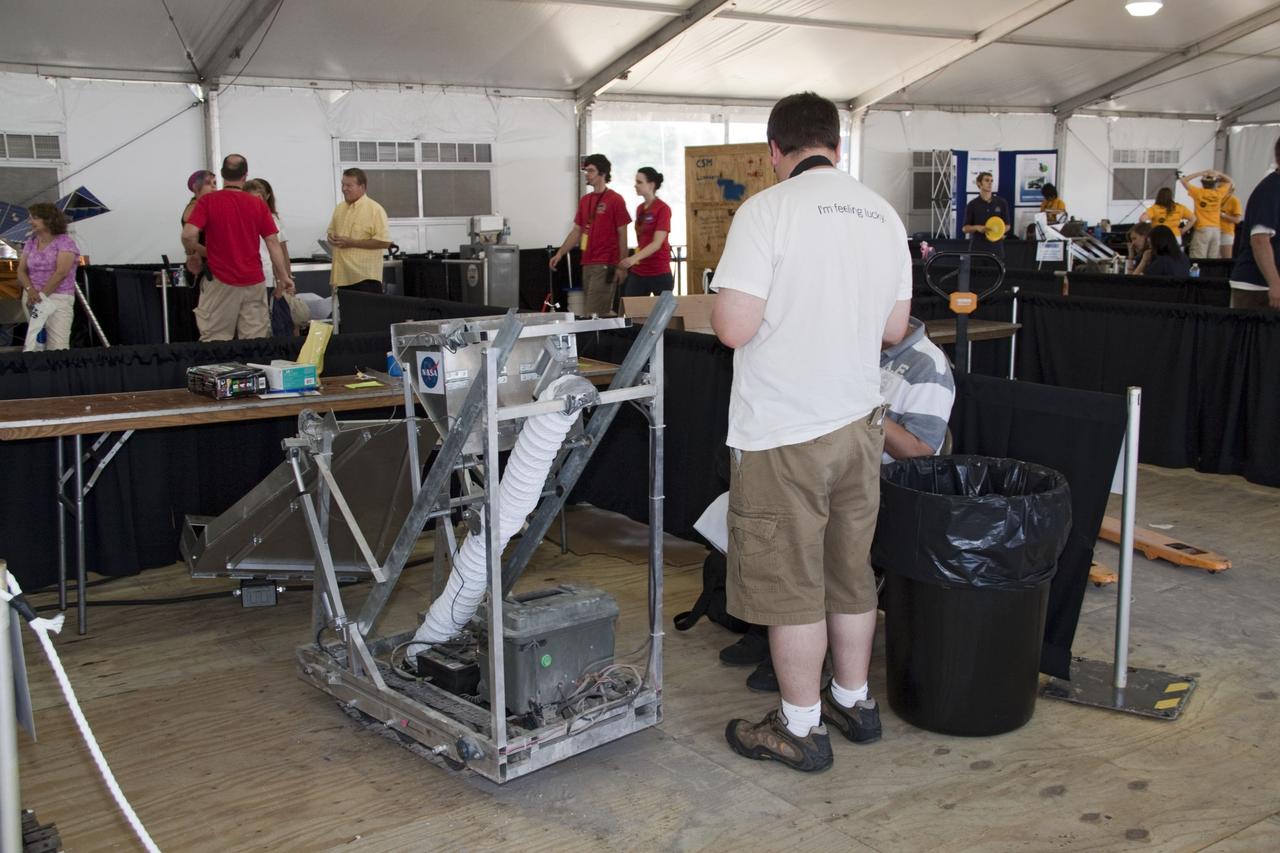 CAPE CANAVERAL, Fla. -- University students wait their turn to compete in NASA's second annual Lunabotics Mining Competition at the Kennedy Space Center Visitor Complex in Florida. hirty-six teams of undergraduate and graduate students from the United States, Bangladesh, Canada, Colombia and India will participate in NASA's Lunabotics Mining Competition May 26 - 28 at the agency's Kennedy Space Center in Florida. The competition is designed to engage and retain students in science, technology, engineering and mathematics (STEM). Teams will maneuver their remote controlled or autonomous excavators, called lunabots, in about 60 tons of ultra-fine simulated lunar soil, called BP-1. The competition is an Exploration Systems Mission Directorate project managed by Kennedy's Education Division. The event also provides a competitive environment that could result in innovative ideas and solutions for NASA's future excavation of the moon. Photo credit: NASA/Jack Pfaller