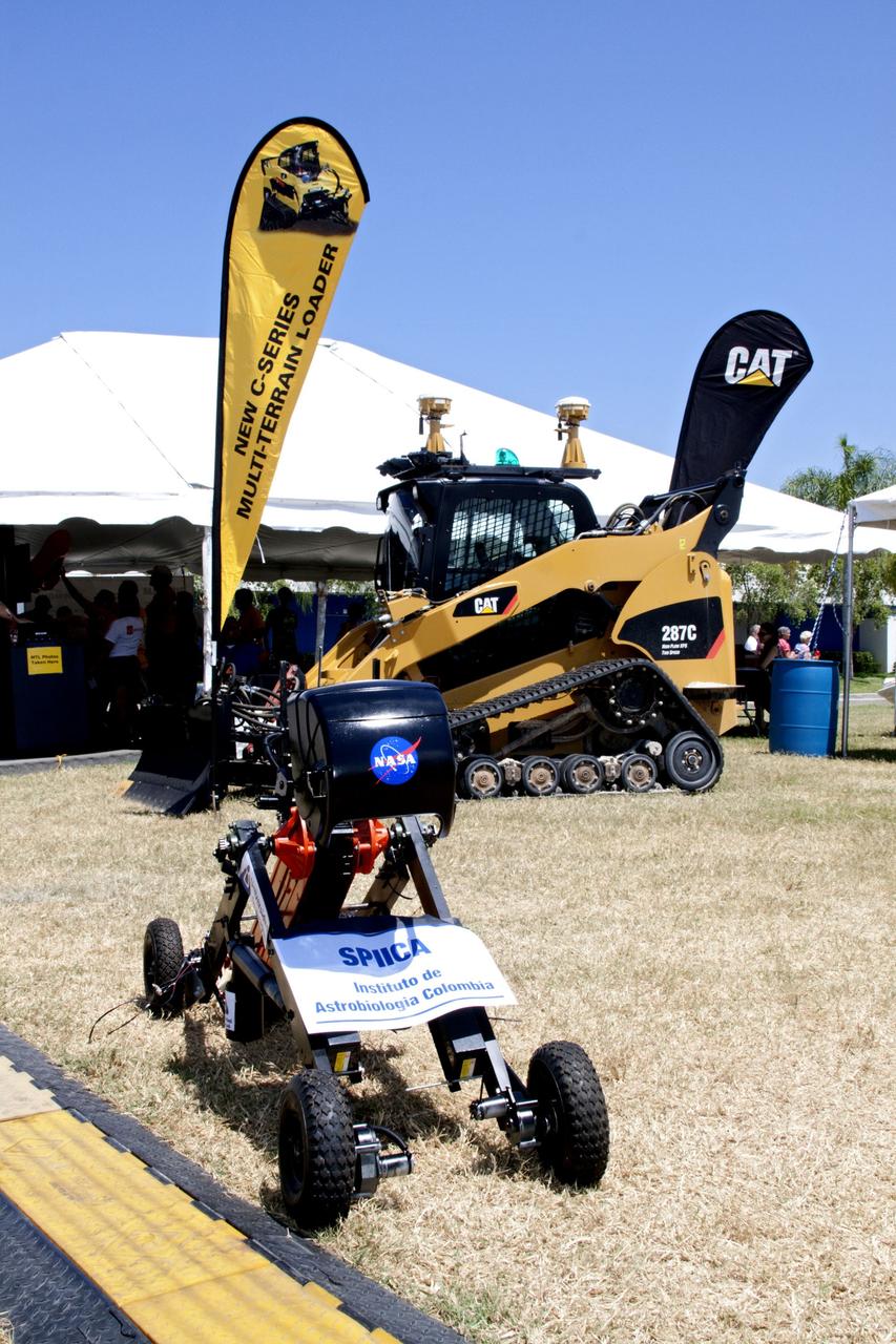 CAPE CANAVERAL, Fla. -- A remote controlled or autonomous excavator, called a lunabot, is on display outside of the "Lunarena" at the Kennedy Space Center Visitor Complex in Florida where university students maneuver their remote controlled lunabots, in a "sand box" of ultra-fine simulated lunar soil during NASA's second annual Lunabotics Mining Competition.    Thirty-six teams of undergraduate and graduate students from the United States, Bangladesh, Canada, Colombia and India will participate in NASA's Lunabotics Mining Competition May 26 - 28 at the agency's Kennedy Space Center in Florida. The competition is designed to engage and retain students in science, technology, engineering and mathematics (STEM). Teams will maneuver their remote controlled or autonomous excavators, called lunabots, in about 60 tons of ultra-fine simulated lunar soil, called BP-1. The competition is an Exploration Systems Mission Directorate project managed by Kennedy's Education Division. The event also provides a competitive environment that could result in innovative ideas and solutions for NASA's future excavation of the moon. Photo credit: NASA/Jack Pfaller