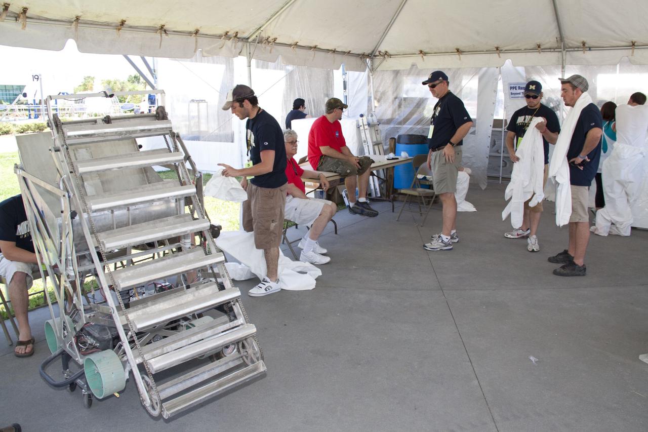 CAPE CANAVERAL, Fla. -- University students wait their turn to compete in NASA's second annual Lunabotics Mining Competition at the Kennedy Space Center Visitor Complex in Florida. Thirty-six teams of undergraduate and graduate students from the United States, Bangladesh, Canada, Colombia and India will participate in NASA's Lunabotics Mining Competition May 26 - 28 at the agency's Kennedy Space Center in Florida. The competition is designed to engage and retain students in science, technology, engineering and mathematics (STEM). Teams will maneuver their remote controlled or autonomous excavators, called lunabots, in about 60 tons of ultra-fine simulated lunar soil, called BP-1. The competition is an Exploration Systems Mission Directorate project managed by Kennedy's Education Division. The event also provides a competitive environment that could result in innovative ideas and solutions for NASA's future excavation of the moon. Photo credit: NASA/Jack Pfaller