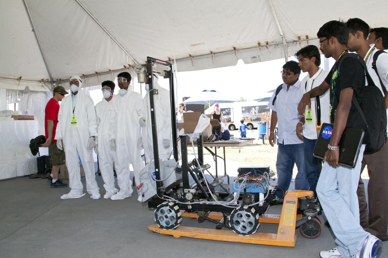 CAPE CANAVERAL, Fla. -- University students wait their turn to compete in NASA's second annual Lunabotics Mining Competition at the Kennedy Space Center Visitor Complex in Florida. Thirty-six teams of undergraduate and graduate students from the United States, Bangladesh, Canada, Colombia and India will participate in NASA's Lunabotics Mining Competition May 26 - 28 at the agency's Kennedy Space Center in Florida. The competition is designed to engage and retain students in science, technology, engineering and mathematics (STEM). Teams will maneuver their remote controlled or autonomous excavators, called lunabots, in about 60 tons of ultra-fine simulated lunar soil, called BP-1. The competition is an Exploration Systems Mission Directorate project managed by Kennedy's Education Division. The event also provides a competitive environment that could result in innovative ideas and solutions for NASA's future excavation of the moon. Photo credit: NASA/Jack Pfaller