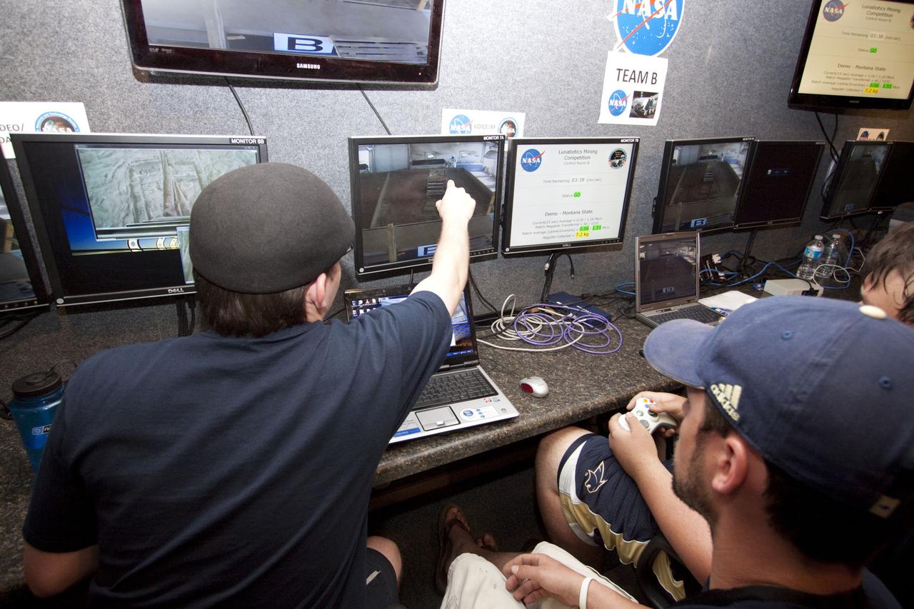 CAPE CANAVERAL, Fla. -- University students monitor their team's remote controlled or autonomous excavator, called a lunabot, as it is maneuvered in a "sand box" of ultra-fine simulated lunar soil during NASA's second annual Lunabotics Mining Competition at the Kennedy Space Center Visitor Complex in Florida. Thirty-six teams of undergraduate and graduate students from the United States, Bangladesh, Canada, Colombia and India will participate in NASA's Lunabotics Mining Competition May 26 - 28 at the agency's Kennedy Space Center in Florida. The competition is designed to engage and retain students in science, technology, engineering and mathematics (STEM). Teams will maneuver their remote controlled or autonomous excavators, called lunabots, in about 60 tons of ultra-fine simulated lunar soil, called BP-1. The competition is an Exploration Systems Mission Directorate project managed by Kennedy's Education Division. The event also provides a competitive environment that could result in innovative ideas and solutions for NASA's future excavation of the moon. Photo credit: NASA/Jack Pfaller