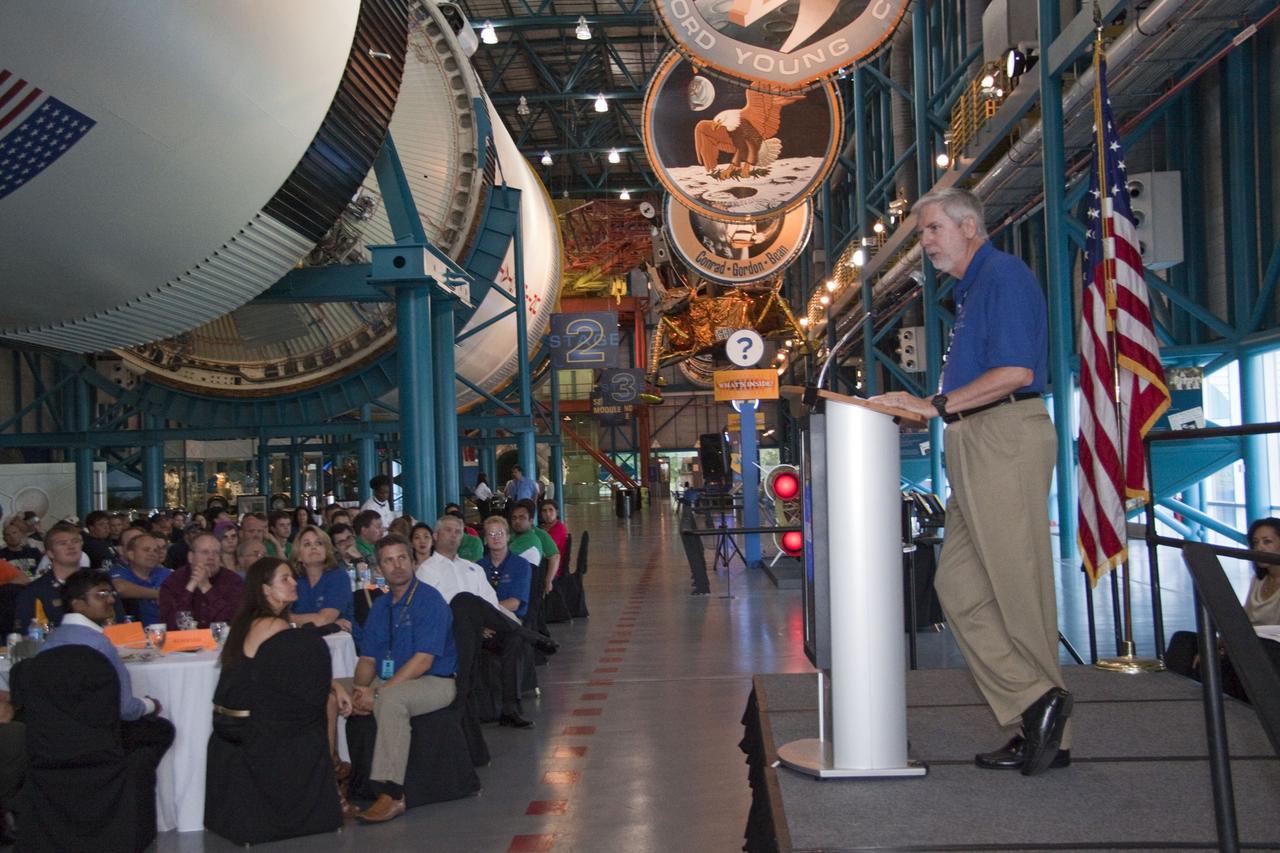 CAPE CANAVERAL, Fla. -- At NASA Kennedy Space Center's Apollo/Saturn V Center, Bill Moore, Visitor Complex chief operating officer speaks to university students at the award ceremony for NASA's second annual Lunabotics Mining Competition.          Thirty-six teams of undergraduate and graduate students from the United States, Bangladesh, Canada, Colombia and India participated in NASA's Lunabotics Mining Competition May 26 - 28 at the agency's Kennedy Space Center in Florida. The competition is designed to engage and retain students in science, technology, engineering and mathematics (STEM). Teams will maneuver their remote controlled or autonomous excavators, called lunabots, in about 60 tons of ultra-fine simulated lunar soil, called BP-1. The competition is an Exploration Systems Mission Directorate project managed by Kennedy's Education Division. The event also provides a competitive environment that could result in innovative ideas and solutions for NASA's future excavation of the moon. Photo credit: NASA/Jack Pfaller