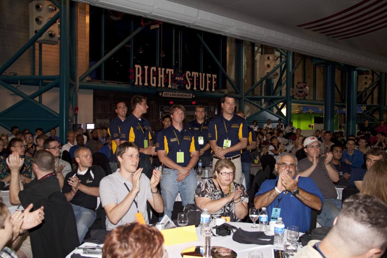 CAPE CANAVERAL, Fla. -- At NASA Kennedy Space Center's Apollo/Saturn V Center, participants applaud the winning team of the competition during the NASA's second annual Lunabotics Mining Competition award ceremony.    Thirty-six teams of undergraduate and graduate students from the United States, Bangladesh, Canada, Colombia and India participated in NASA's Lunabotics Mining Competition May 26 - 28 at the agency's Kennedy Space Center in Florida. The competition is designed to engage and retain students in science, technology, engineering and mathematics (STEM). Teams will maneuver their remote controlled or autonomous excavators, called lunabots, in about 60 tons of ultra-fine simulated lunar soil, called BP-1. The competition is an Exploration Systems Mission Directorate project managed by Kennedy's Education Division. The event also provides a competitive environment that could result in innovative ideas and solutions for NASA's future excavation of the moon. Photo credit: NASA/Jack Pfaller
