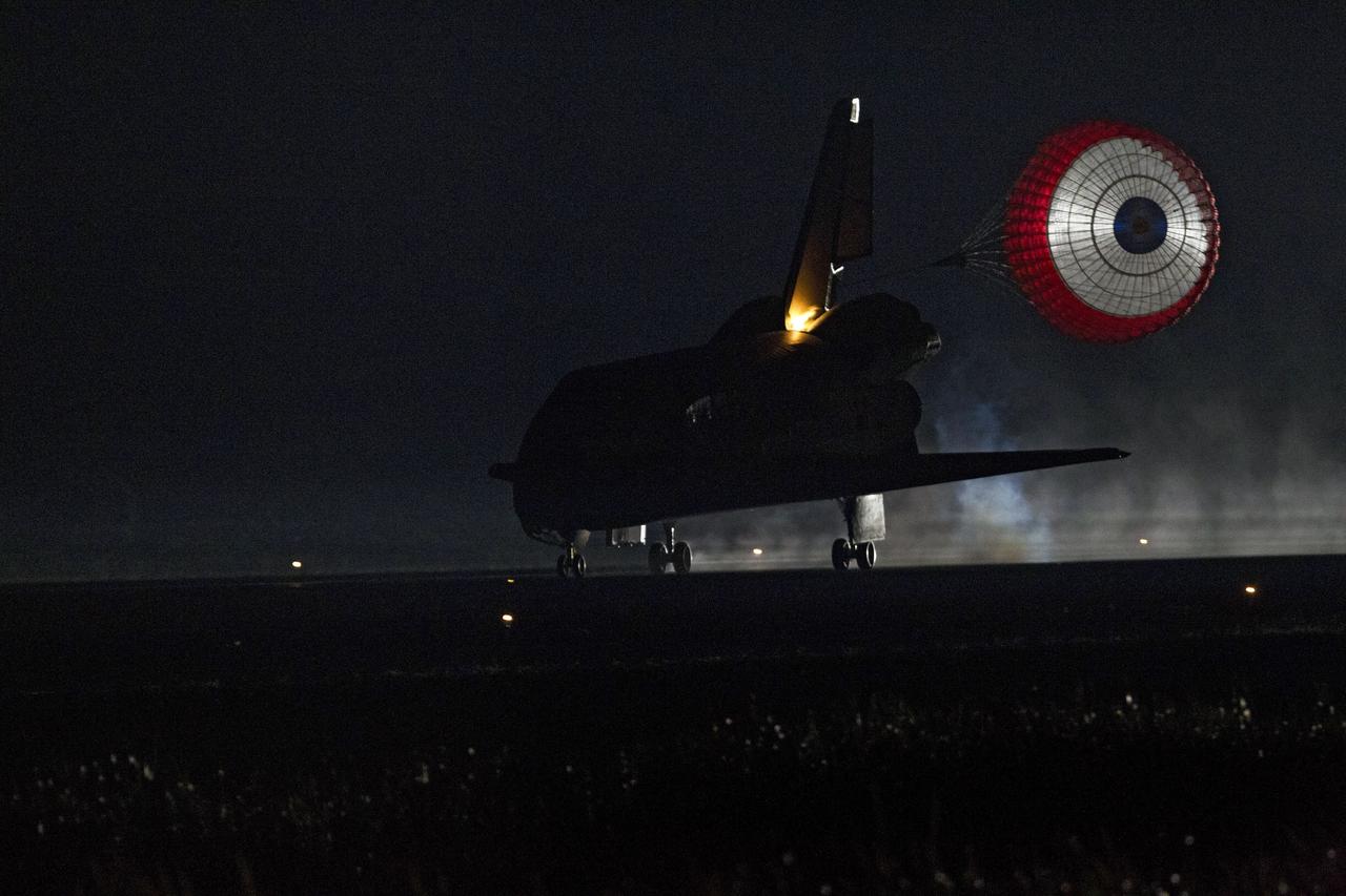 CAPE CANAVERAL, Fla. -- Xenon lights illuminate space shuttle Endeavour's unfurled drag chute as the vehicle rolls to a stop on the Shuttle Landing Facility's Runway 15 at NASA's Kennedy Space Center in Florida for the final time. Main gear touchdown was at 2:34:51 a.m. EDT, followed by nose gear touchdown at 2:35:04 a.m., and wheelstop at 2:35:36 a.m. On board are STS-134 Commander Mark Kelly, Pilot Greg H. Johnson, and Mission Specialists Mike Fincke, Drew Feustel, Greg Chamitoff and the European Space Agency's Roberto Vittori.      STS-134 delivered the Alpha Magnetic Spectrometer-2 (AMS) and the Express Logistics Carrier-3 (ELC-3) to the International Space Station. AMS will help researchers understand the origin of the universe and search for evidence of dark matter, strange matter and antimatter from the station. ELC-3 carried spare parts that will sustain station operations once the shuttles are retired from service. STS-134 was the 25th and final flight for Endeavour, which has spent 299 days in space, orbited Earth 4,671 times and traveled 122,883,151 miles. Photo credit: NASA/Tony Gray