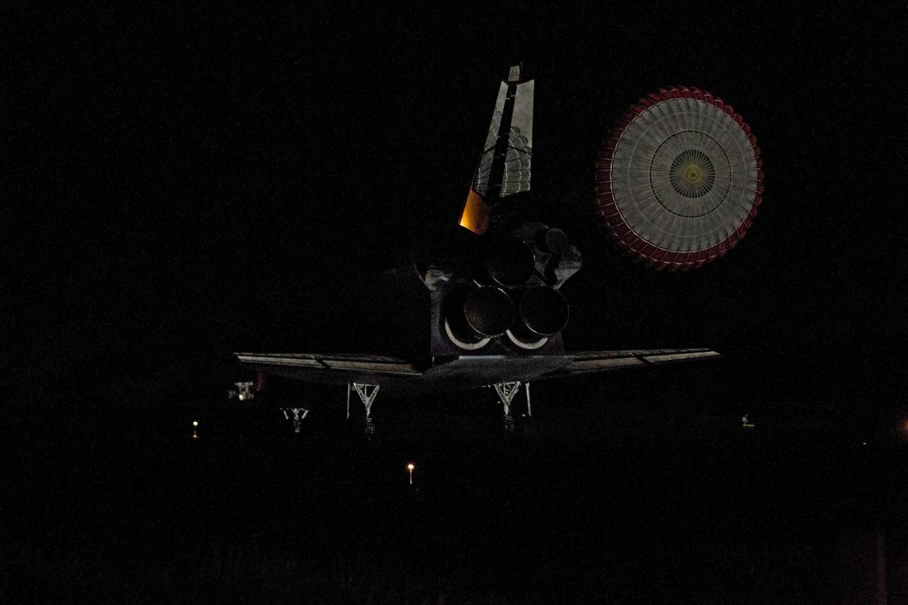 CAPE CANAVERAL, Fla. -- Space shuttle Endeavour's drag chute is reflected on the vehicle's tail end as it rolls to a stop on the Shuttle Landing Facility's Runway 15 at NASA's Kennedy Space Center in Florida for the final time. Main gear touchdown was at 2:34:51 a.m. EDT, followed by nose gear touchdown at 2:35:04 a.m., and wheelstop at 2:35:36 a.m. On board are STS-134 Commander Mark Kelly, Pilot Greg H. Johnson, and Mission Specialists Mike Fincke, Drew Feustel, Greg Chamitoff and the European Space Agency's Roberto Vittori. STS-134 delivered the Alpha Magnetic Spectrometer-2 (AMS) and the Express Logistics Carrier-3 (ELC-3) to the International Space Station. AMS will help researchers understand the origin of the universe and search for evidence of dark matter, strange matter and antimatter from the station. ELC-3 carried spare parts that will sustain station operations once the shuttles are retired from service. STS-134 was the 25th and final flight for Endeavour, which has spent 299 days in space, orbited Earth 4,671 times and traveled 122,883,151 miles. Photo credit: NASA/Tony Gray