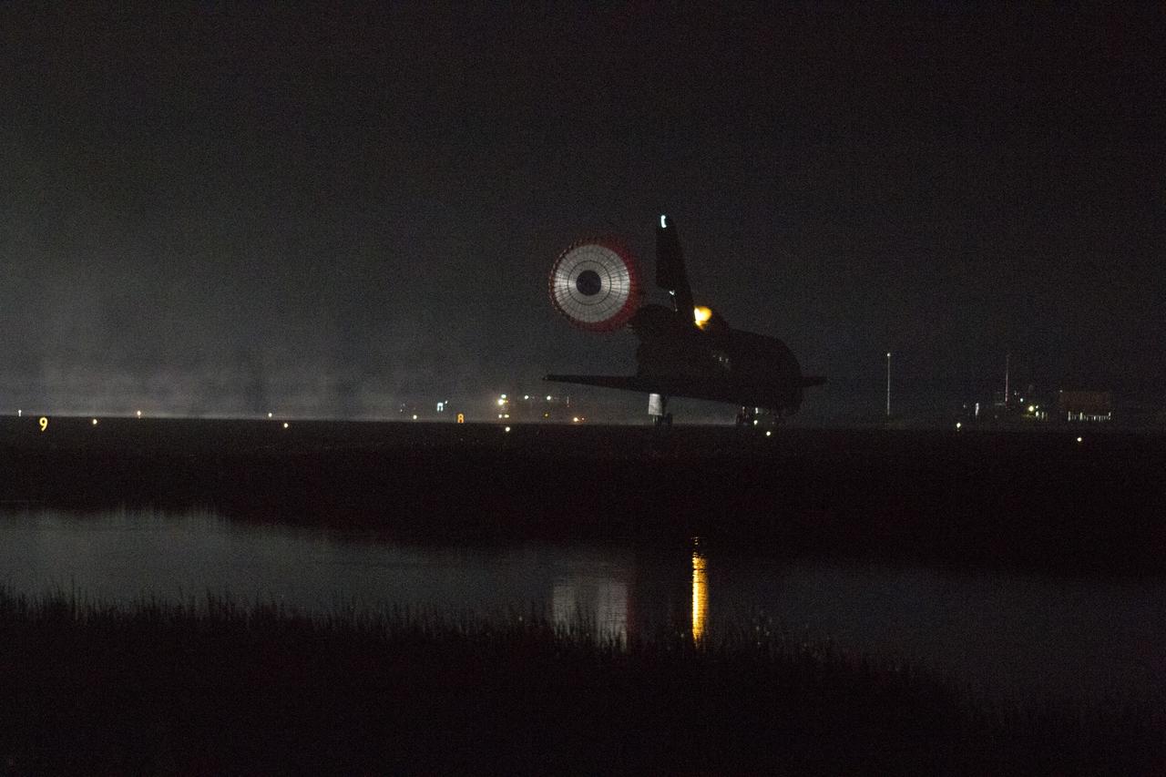 CAPE CANAVERAL, Fla. -- Xenon lights illuminate space shuttle Endeavour's unfurled drag chute as the vehicle rolls to a stop on the Shuttle Landing Facility's Runway 15 at NASA's Kennedy Space Center in Florida for the final time. Heat from the shuttle's auxiliary power units (APUs), which provide hydraulic control, can be seen at the back of Endeavour, near the vertical tail. Main gear touchdown was at 2:34:51 a.m. EDT, followed by nose gear touchdown at 2:35:04 a.m., and wheelstop at 2:35:36 a.m. On board are STS-134 Commander Mark Kelly, Pilot Greg H. Johnson, and Mission Specialists Mike Fincke, Drew Feustel, Greg Chamitoff and the European Space Agency's Roberto Vittori.      STS-134 delivered the Alpha Magnetic Spectrometer-2 (AMS) and the Express Logistics Carrier-3 (ELC-3) to the International Space Station. AMS will help researchers understand the origin of the universe and search for evidence of dark matter, strange matter and antimatter from the station. ELC-3 carried spare parts that will sustain station operations once the shuttles are retired from service. STS-134 was the 25th and final flight for Endeavour, which has spent 299 days in space, orbited Earth 4,671 times and traveled 122,883,151 miles. Photo credit: NASA/Kenny Allen