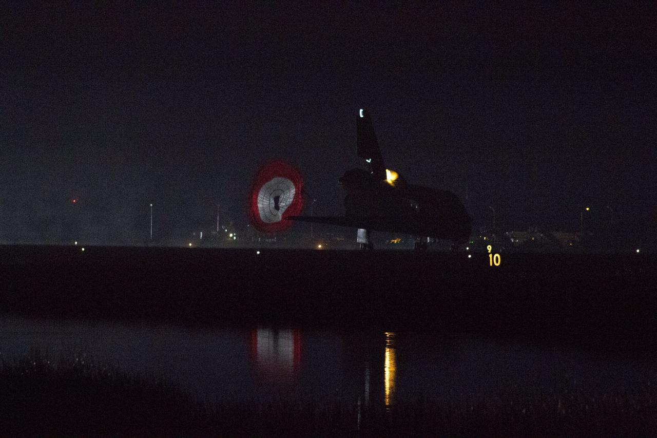 CAPE CANAVERAL, Fla. -- Space shuttle Endeavour rolls to a stop on the Shuttle Landing Facility's Runway 15 at NASA's Kennedy Space Center in Florida for the final time. Heat from the shuttle's auxiliary power units (APUs), which provide hydraulic control, can be seen at the back of Endeavour, near the vertical tail. Main gear touchdown was at 2:34:51 a.m. EDT, followed by nose gear touchdown at 2:35:04 a.m., and wheelstop at 2:35:36 a.m. On board are STS-134 Commander Mark Kelly, Pilot Greg H. Johnson, and Mission Specialists Mike Fincke, Drew Feustel, Greg Chamitoff and the European Space Agency's Roberto Vittori. STS-134 delivered the Alpha Magnetic Spectrometer-2 (AMS) and the Express Logistics Carrier-3 (ELC-3) to the International Space Station. AMS will help researchers understand the origin of the universe and search for evidence of dark matter, strange matter and antimatter from the station. ELC-3 carried spare parts that will sustain station operations once the shuttles are retired from service. STS-134 was the 25th and final flight for Endeavour, which has spent 299 days in space, orbited Earth 4,671 times and traveled 122,883,151 miles. Photo credit: NASA/Kenny Allen