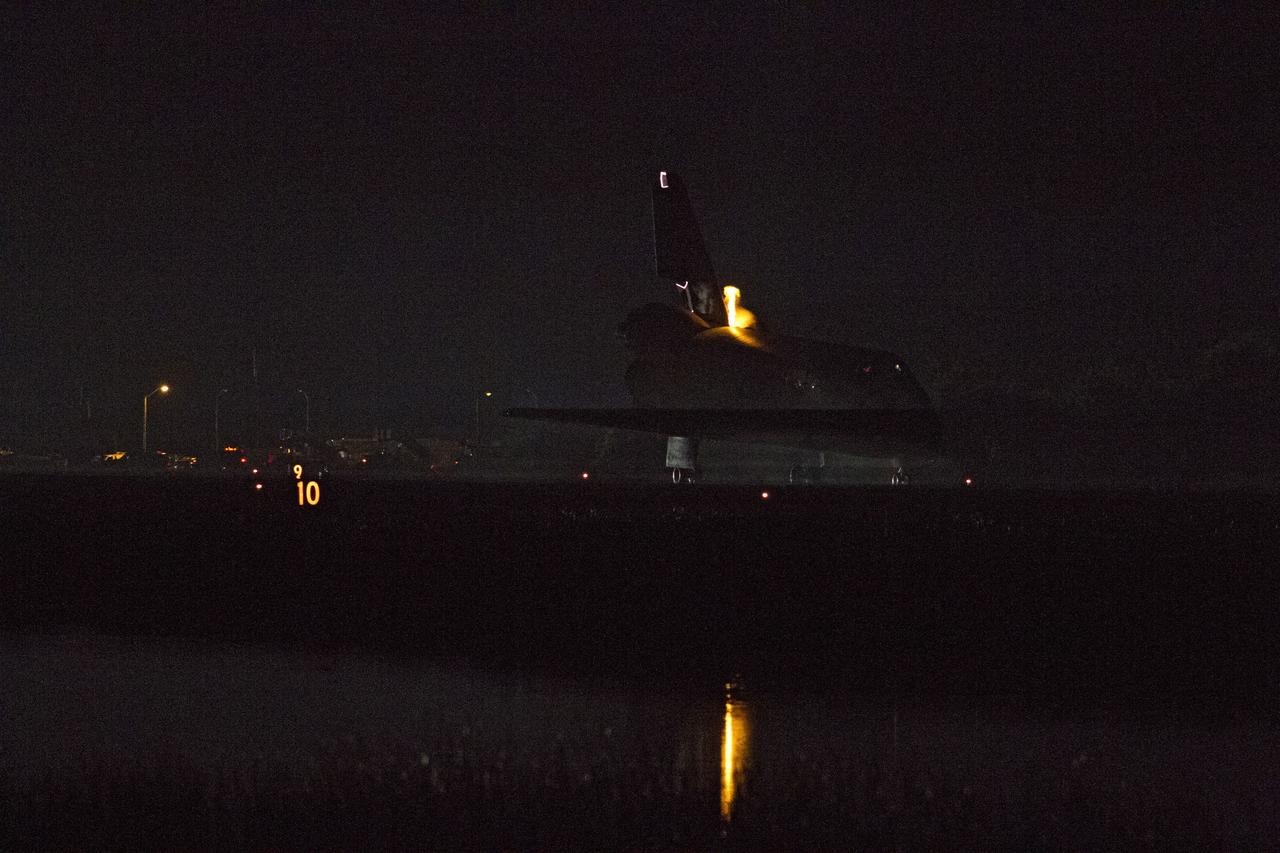 CAPE CANAVERAL, Fla. -- Heat from space shuttle Endeavour's auxiliary power units (APUs), which provide hydraulic control, can be seen at the back of the shuttle, near the vertical tail. Endeavour landed for the final time on the Shuttle Landing Facility's Runway 15 at NASA's Kennedy Space Center in Florida, marking the 25th night landing of the Space Shuttle Program. Main gear touchdown was at 2:34:51 a.m. EDT, followed by nose gear touchdown at 2:35:04 a.m., and wheelstop at 2:35:36 a.m. On board are STS-134 Commander Mark Kelly, Pilot Greg H. Johnson, and Mission Specialists Mike Fincke, Drew Feustel, Greg Chamitoff and the European Space Agency's Roberto Vittori. STS-134 delivered the Alpha Magnetic Spectrometer-2 (AMS) and the Express Logistics Carrier-3 (ELC-3) to the International Space Station. AMS will help researchers understand the origin of the universe and search for evidence of dark matter, strange matter and antimatter from the station. ELC-3 carried spare parts that will sustain station operations once the shuttles are retired from service. STS-134 was the 25th and final flight for Endeavour, which has spent 299 days in space, orbited Earth 4,671 times and traveled 122,883,151 miles. Photo credit: NASA/Kenny Allen