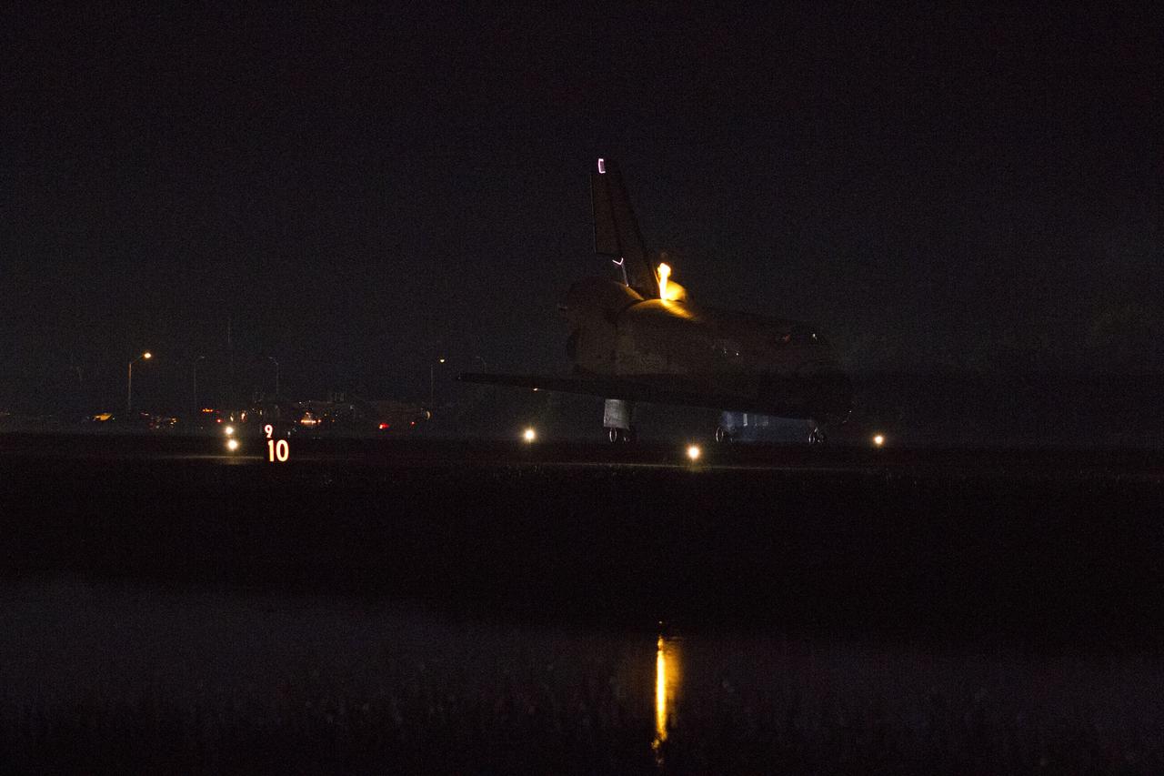 CAPE CANAVERAL, Fla. -- Heat from space shuttle Endeavour's auxiliary power units (APUs), which provide hydraulic control, can be seen at the back of the shuttle, near the vertical tail. Endeavour landed for the final time on the Shuttle Landing Facility's Runway 15 at NASA's Kennedy Space Center in Florida, marking the 25th night landing of the Space Shuttle Program. Main gear touchdown was at 2:34:51 a.m. EDT, followed by nose gear touchdown at 2:35:04 a.m., and wheelstop at 2:35:36 a.m. On board are STS-134 Commander Mark Kelly, Pilot Greg H. Johnson, and Mission Specialists Mike Fincke, Drew Feustel, Greg Chamitoff and the European Space Agency's Roberto Vittori. STS-134 delivered the Alpha Magnetic Spectrometer-2 (AMS) and the Express Logistics Carrier-3 (ELC-3) to the International Space Station. AMS will help researchers understand the origin of the universe and search for evidence of dark matter, strange matter and antimatter from the station. ELC-3 carried spare parts that will sustain station operations once the shuttles are retired from service. STS-134 was the 25th and final flight for Endeavour, which has spent 299 days in space, orbited Earth 4,671 times and traveled 122,883,151 miles. Photo credit: NASA/Kenny Allen