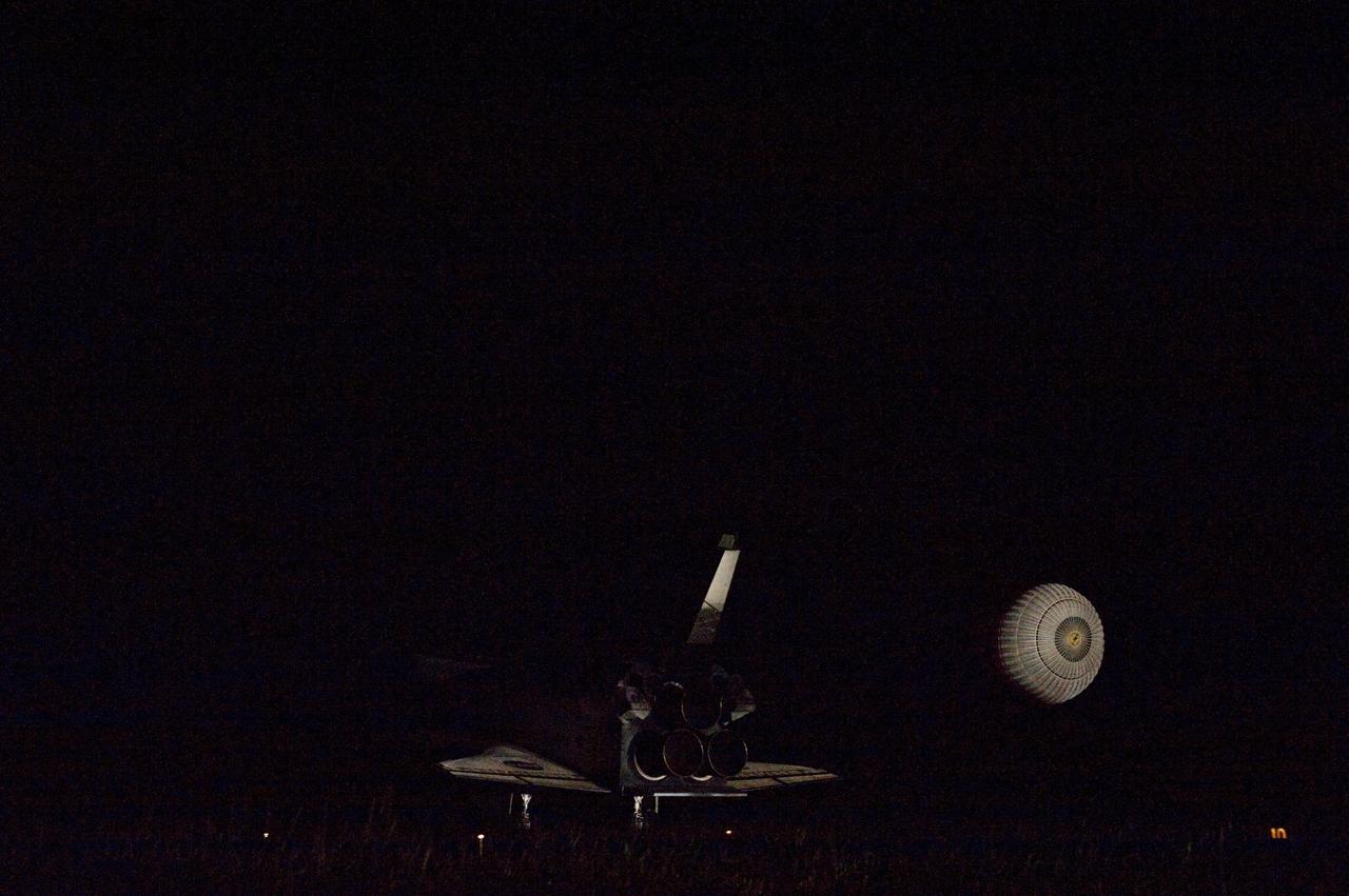CAPE CANAVERAL, Fla. -- Xenon lights illuminate space shuttle Endeavour's unfurled drag chute as the vehicle rolls to a stop on the Shuttle Landing Facility's Runway 15 at NASA's Kennedy Space Center in Florida for the final time. Main gear touchdown was at 2:34:51 a.m. EDT, followed by nose gear touchdown at 2:35:04 a.m., and wheelstop at 2:35:36 a.m. On board are STS-134 Commander Mark Kelly, Pilot Greg H. Johnson, and Mission Specialists Mike Fincke, Drew Feustel, Greg Chamitoff and the European Space Agency's Roberto Vittori. STS-134 delivered the Alpha Magnetic Spectrometer-2 (AMS) and the Express Logistics Carrier-3 (ELC-3) to the International Space Station. AMS will help researchers understand the origin of the universe and search for evidence of dark matter, strange matter and antimatter from the station. ELC-3 carried spare parts that will sustain station operations once the shuttles are retired from service. STS-134 was the 25th and final flight for Endeavour, which has spent 299 days in space, orbited Earth 4,671 times and traveled 122,883,151 miles. Photo credit: NASA/Tom Farrar