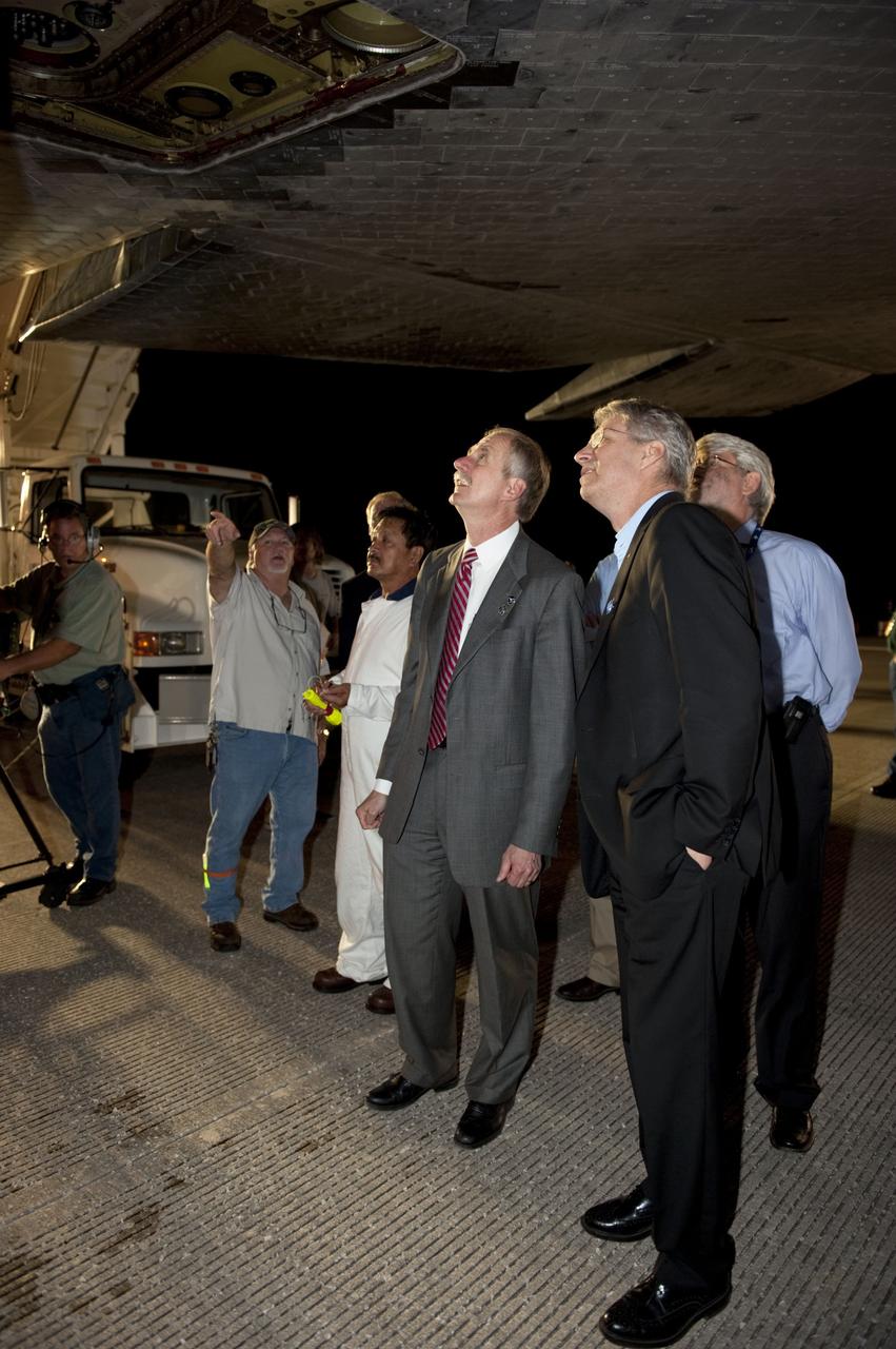 CAPE CANAVERAL, Fla. -- Managers check out the heat shield tiles that protected space shuttle Endeavour on its successful trip home to the Shuttle Landing Facility's Runway 15 at NASA's Kennedy Space Center in Florida. Endeavour's final return from space completed the 16-day, 6.5-million-mile STS-134 mission. Main gear touchdown was at 2:34:51 a.m. EDT, followed by nose gear touchdown at 2:35:04 a.m., and wheelstop at 2:35:36 a.m.  STS-134 delivered the Alpha Magnetic Spectrometer-2 (AMS) and the Express Logistics Carrier-3 (ELC-3) to the International Space Station. AMS will help researchers understand the origin of the universe and search for evidence of dark matter, strange matter and antimatter from the station. ELC-3 carried spare parts that will sustain station operations once the shuttles are retired from service. STS-134 was the 25th and final flight for Endeavour, which spent 299 days in space, orbited Earth 4,671 times and traveled 122,883,151 miles. Photo credit: NASA/Kim Shiflett
