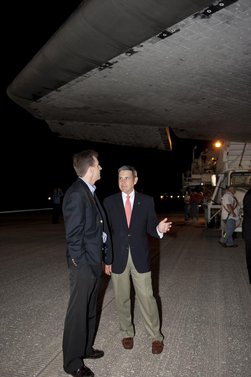 CAPE CANAVERAL, Fla. -- NASA's Deputy Manager for the Space Shuttle Program Leroy Cain, left, and Kennedy Center Director Bob Cabana chat underneath the belly of space shuttle Endeavour following the vehicle's successful trip home. Endeavour's final return from space completed the 16-day, 6.5-million-mile STS-134 mission. Main gear touchdown on the Shuttle Landing Facility's Runway 15 was at 2:34:51 a.m. EDT, followed by nose gear touchdown at 2:35:04 a.m., and wheelstop at 2:35:36 a.m.  STS-134 delivered the Alpha Magnetic Spectrometer-2 (AMS) and the Express Logistics Carrier-3 (ELC-3) to the International Space Station. AMS will help researchers understand the origin of the universe and search for evidence of dark matter, strange matter and antimatter from the station. ELC-3 carried spare parts that will sustain station operations once the shuttles are retired from service. STS-134 was the 25th and final flight for Endeavour, which spent 299 days in space, orbited Earth 4,671 times and traveled 122,883,151 miles. Photo credit: NASA/Kim Shiflett