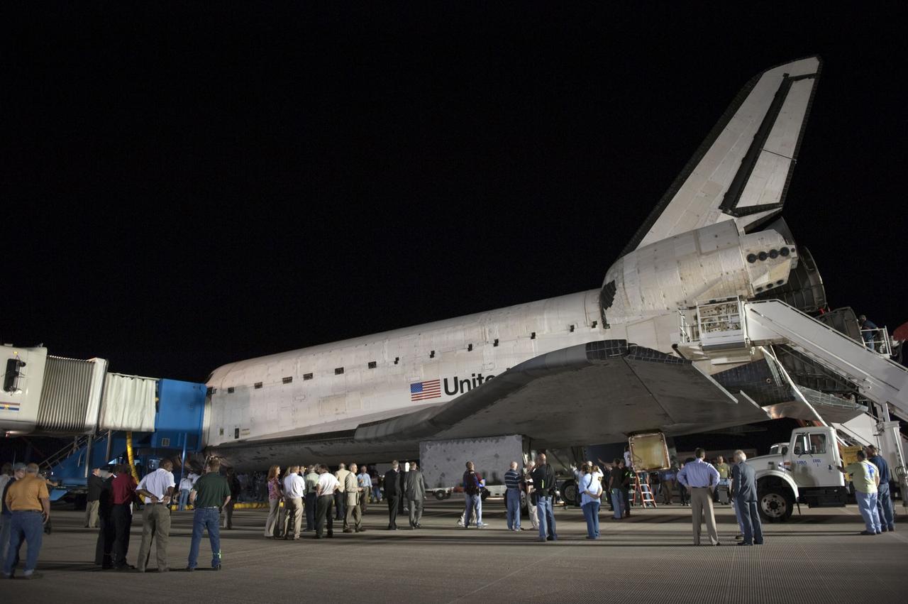 CAPE CANAVERAL, Fla. -- Employees admire space shuttle Endeavour as the landing convoy makes the vehicle safe and secure for towing to its processing hangar at NASA's Kennedy Space Center in Florida. Endeavour's final return from space completed the 16-day, 6.5-million-mile STS-134 mission. Main gear touchdown on the Shuttle Landing Facility's Runway 15 was at 2:34:51 a.m. EDT, followed by nose gear touchdown at 2:35:04 a.m., and wheelstop at 2:35:36 a.m.  STS-134 delivered the Alpha Magnetic Spectrometer-2 (AMS) and the Express Logistics Carrier-3 (ELC-3) to the International Space Station. AMS will help researchers understand the origin of the universe and search for evidence of dark matter, strange matter and antimatter from the station. ELC-3 carried spare parts that will sustain station operations once the shuttles are retired from service. STS-134 was the 25th and final flight for Endeavour, which spent 299 days in space, orbited Earth 4,671 times and traveled 122,883,151 miles. Photo credit: NASA/Kim Shiflett
