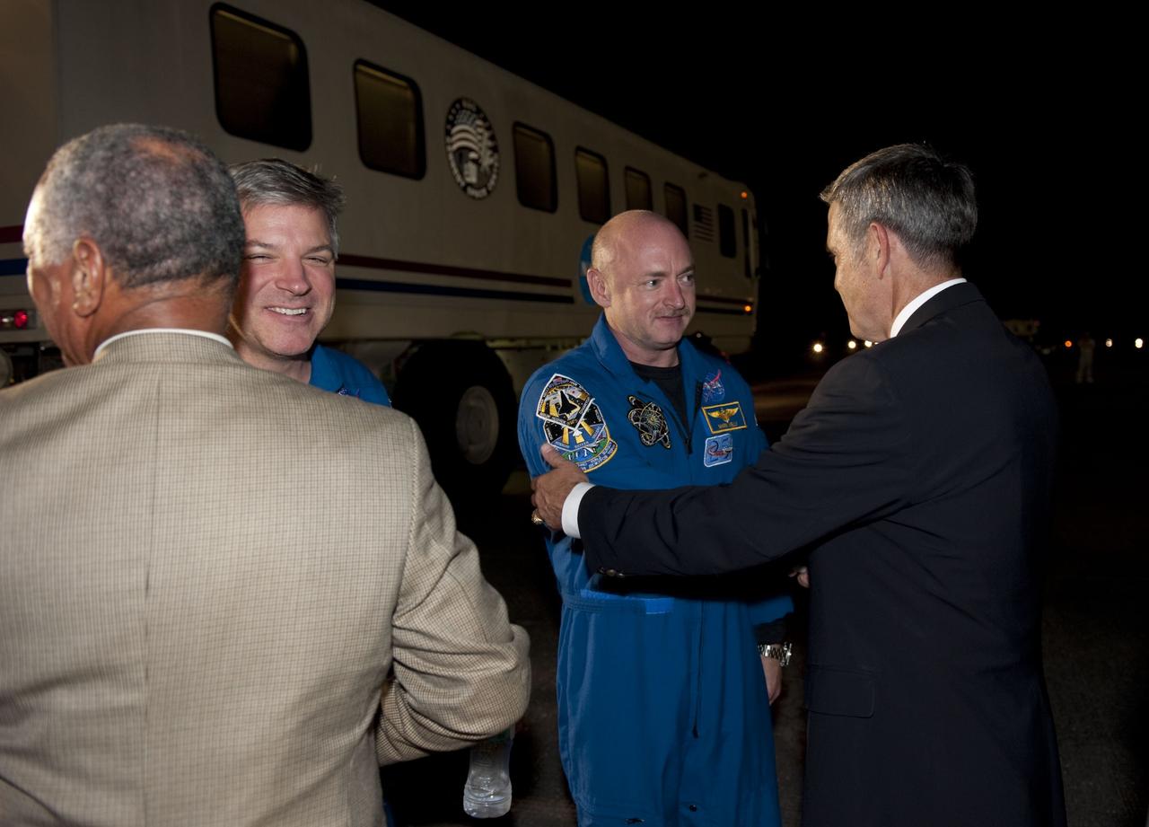 CAPE CANAVERAL, Fla. -- NASA Administrator Charlie Bolden, left, and NASA Kennedy Space Center Director Bob Cabana greet space shuttle Endeavour's STS-134 commander and pilot following their successful trip home. Endeavour's final return from space completed the 16-day, 6.5-million-mile STS-134 mission. Main gear touchdown on the Shuttle Landing Facility's Runway 15 was at 2:34:51 a.m. EDT, followed by nose gear touchdown at 2:35:04 a.m., and wheelstop at 2:35:36 a.m.  STS-134 delivered the Alpha Magnetic Spectrometer-2 (AMS) and the Express Logistics Carrier-3 (ELC-3) to the International Space Station. AMS will help researchers understand the origin of the universe and search for evidence of dark matter, strange matter and antimatter from the station. ELC-3 carried spare parts that will sustain station operations once the shuttles are retired from service. STS-134 was the 25th and final flight for Endeavour, which spent 299 days in space, orbited Earth 4,671 times and traveled 122,883,151 miles. Photo credit: NASA/Kim Shiflett