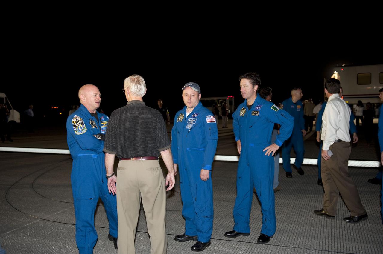 CAPE CANAVERAL, Fla. -- Space shuttle Endeavour's STS-134 crew members talk with employees following their successful trip home. Endeavour's final return from space completed the 16-day, 6.5-million-mile STS-134 mission. Main gear touchdown on the Shuttle Landing Facility's Runway 15 was at 2:34:51 a.m. EDT, followed by nose gear touchdown at 2:35:04 a.m., and wheelstop at 2:35:36 a.m.  STS-134 delivered the Alpha Magnetic Spectrometer-2 (AMS) and the Express Logistics Carrier-3 (ELC-3) to the International Space Station. AMS will help researchers understand the origin of the universe and search for evidence of dark matter, strange matter and antimatter from the station. ELC-3 carried spare parts that will sustain station operations once the shuttles are retired from service. STS-134 was the 25th and final flight for Endeavour, which spent 299 days in space, orbited Earth 4,671 times and traveled 122,883,151 miles. Photo credit: NASA/Kim Shiflett