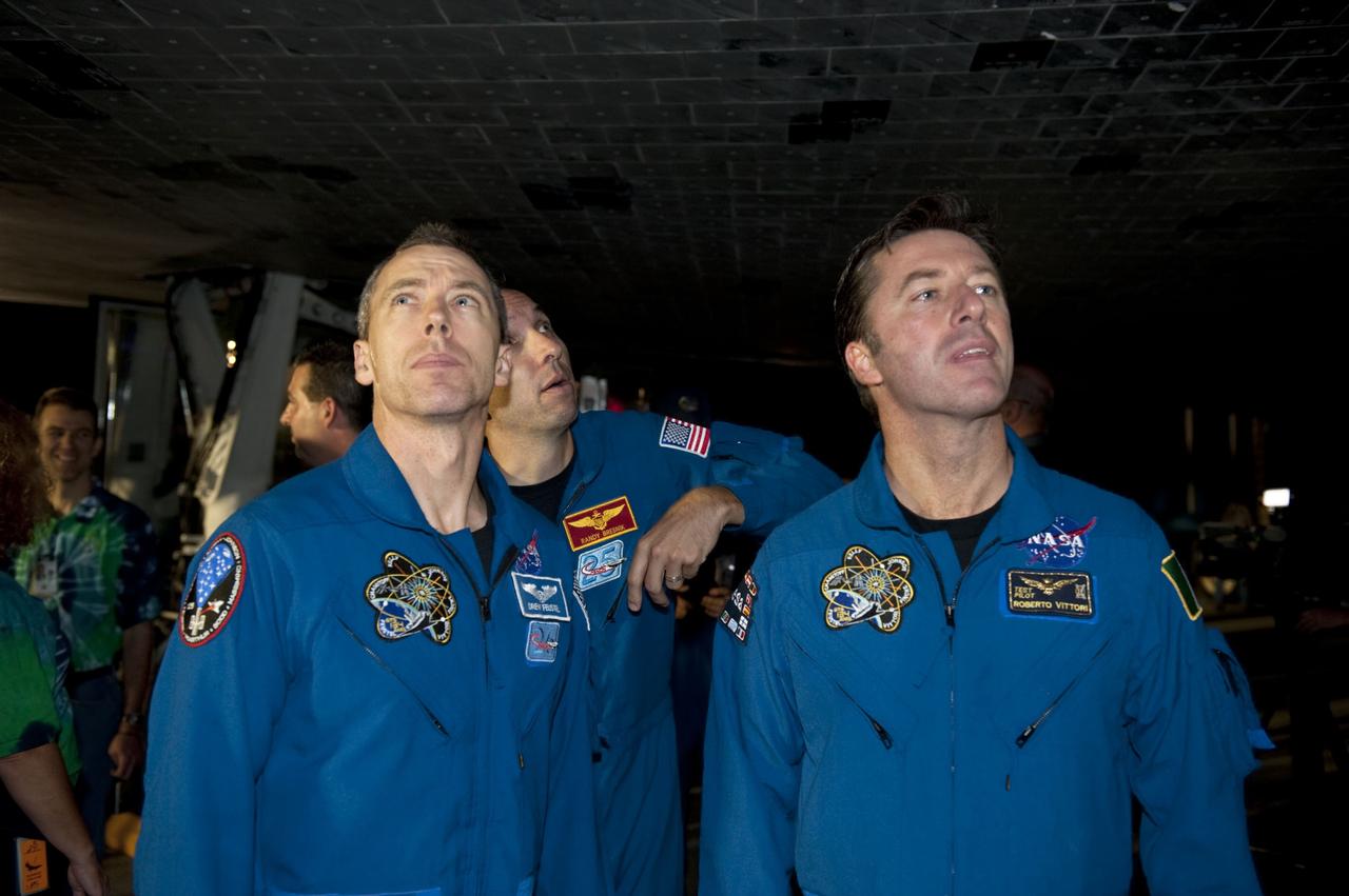 CAPE CANAVERAL, Fla. -- STS-134 Mission Specialists Drew Feustel, left, and Roberto Vittori with the European Space Agency, right, admire space shuttle Endeavour with NASA astronaut Randy Bresnik at NASA's Kennedy Space Center in Florida. Endeavour's final return from space completed the 16-day, 6.5-million-mile STS-134 mission. Main gear touchdown on the Shuttle Landing Facility's Runway 15 was at 2:34:51 a.m. EDT, followed by nose gear touchdown at 2:35:04 a.m., and wheelstop at 2:35:36 a.m.   STS-134 delivered the Alpha Magnetic Spectrometer-2 (AMS) and the Express Logistics Carrier-3 (ELC-3) to the International Space Station. AMS will help researchers understand the origin of the universe and search for evidence of dark matter, strange matter and antimatter from the station. ELC-3 carried spare parts that will sustain station operations once the shuttles are retired from service. STS-134 was the 25th and final flight for Endeavour, which spent 299 days in space, orbited Earth 4,671 times and traveled 122,883,151 miles. Photo credit: NASA/Kim Shiflett