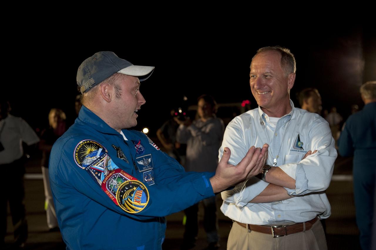 CAPE CANAVERAL, Fla. -- STS-134 Mission Specialists Mike Fincke, left, chats with STS-134 Assistant Launch Director Pete Nickolenko following the successful return of space shuttle Endeavour to NASA's Kennedy Space Center in Florida. Endeavour's final return from space completed the 16-day, 6.5-million-mile STS-134 mission. Main gear touchdown on the Shuttle Landing Facility's Runway 15 was at 2:34:51 a.m. EDT, followed by nose gear touchdown at 2:35:04 a.m., and wheelstop at 2:35:36 a.m.  STS-134 delivered the Alpha Magnetic Spectrometer-2 (AMS) and the Express Logistics Carrier-3 (ELC-3) to the International Space Station. AMS will help researchers understand the origin of the universe and search for evidence of dark matter, strange matter and antimatter from the station. ELC-3 carried spare parts that will sustain station operations once the shuttles are retired from service. STS-134 was the 25th and final flight for Endeavour, which spent 299 days in space, orbited Earth 4,671 times and traveled 122,883,151 miles. Photo credit: NASA/Kim Shiflett