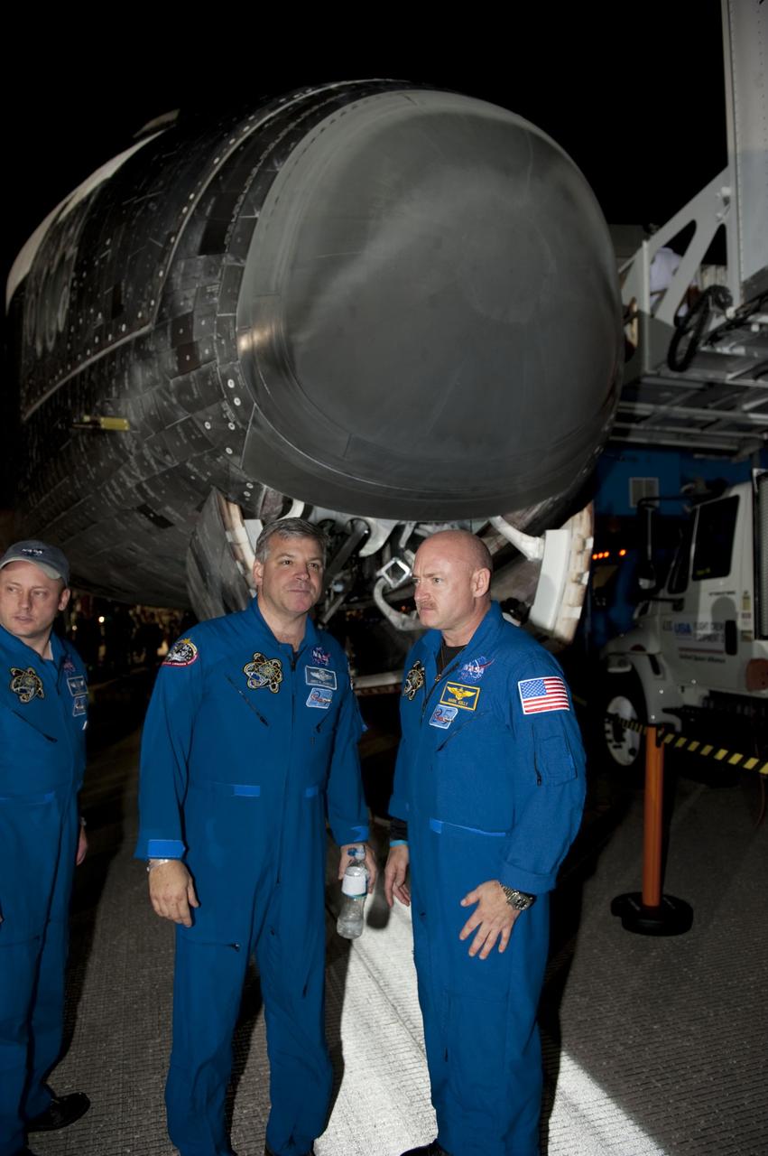 CAPE CANAVERAL, Fla. -- STS-134 Mission Specialist Mike Fincke, left, Pilot Greg H. Johnson and Commander Mark Kelly talk with employees following the successful return of space shuttle Endeavour to NASA's Kennedy Space Center in Florida. Endeavour's final return from space completed the 16-day, 6.5-million-mile STS-134 mission. Main gear touchdown on the Shuttle Landing Facility's Runway 15 was at 2:34:51 a.m. EDT, followed by nose gear touchdown at 2:35:04 a.m., and wheelstop at 2:35:36 a.m.  STS-134 delivered the Alpha Magnetic Spectrometer-2 (AMS) and the Express Logistics Carrier-3 (ELC-3) to the International Space Station. AMS will help researchers understand the origin of the universe and search for evidence of dark matter, strange matter and antimatter from the station. ELC-3 carried spare parts that will sustain station operations once the shuttles are retired from service. STS-134 was the 25th and final flight for Endeavour, which spent 299 days in space, orbited Earth 4,671 times and traveled 122,883,151 miles. Photo credit: NASA/Kim Shiflett