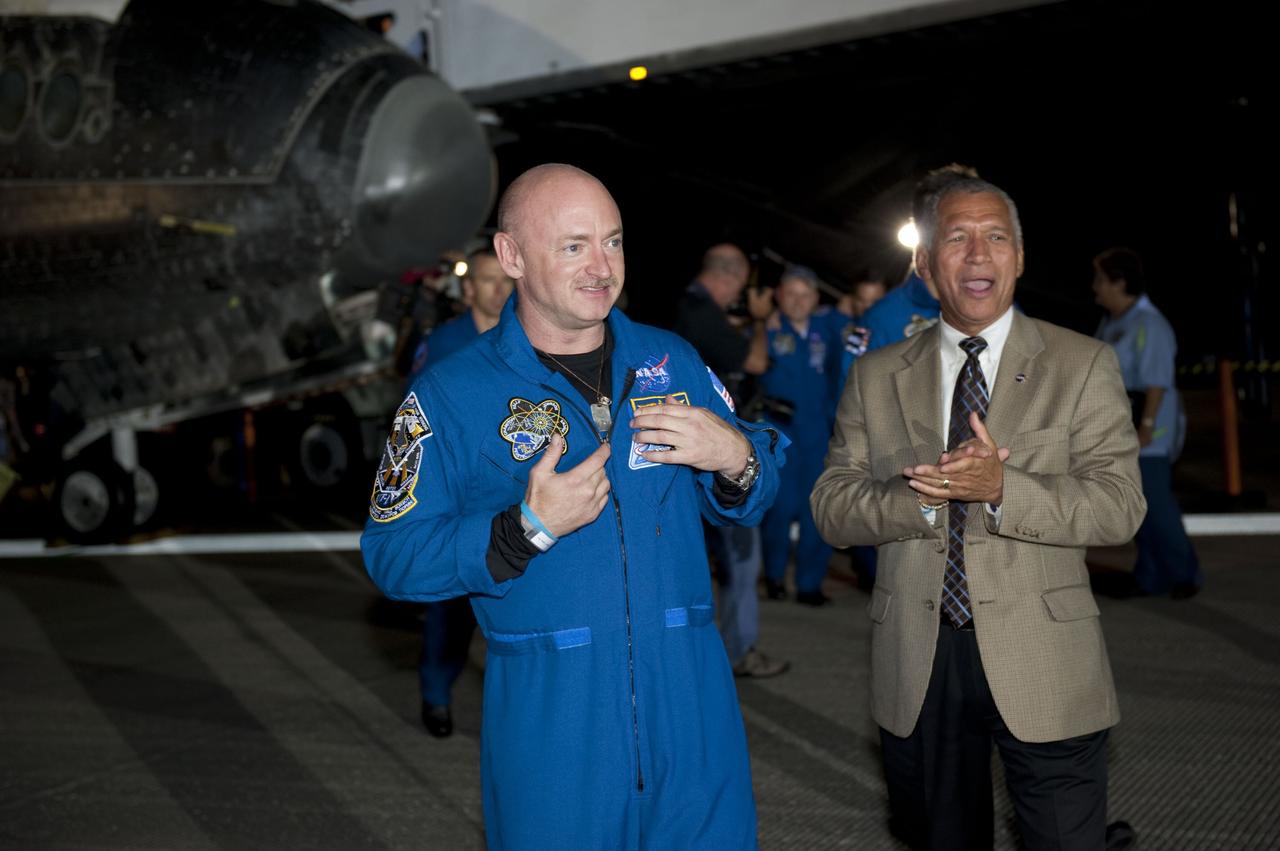 CAPE CANAVERAL, Fla. -- STS-134 Commander Mark Kelly, left, and NASA Administrator Charlie Bolden chat with employees following the successful return of space shuttle Endeavour to NASA's Kennedy Space Center in Florida. Endeavour's final return from space completed the 16-day, 6.5-million-mile STS-134 mission. Main gear touchdown on the Shuttle Landing Facility's Runway 15 was at 2:34:51 a.m. EDT, followed by nose gear touchdown at 2:35:04 a.m., and wheelstop at 2:35:36 a.m.  STS-134 delivered the Alpha Magnetic Spectrometer-2 (AMS) and the Express Logistics Carrier-3 (ELC-3) to the International Space Station. AMS will help researchers understand the origin of the universe and search for evidence of dark matter, strange matter and antimatter from the station. ELC-3 carried spare parts that will sustain station operations once the shuttles are retired from service. STS-134 was the 25th and final flight for Endeavour, which spent 299 days in space, orbited Earth 4,671 times and traveled 122,883,151 miles. Photo credit: NASA/Kim Shiflett