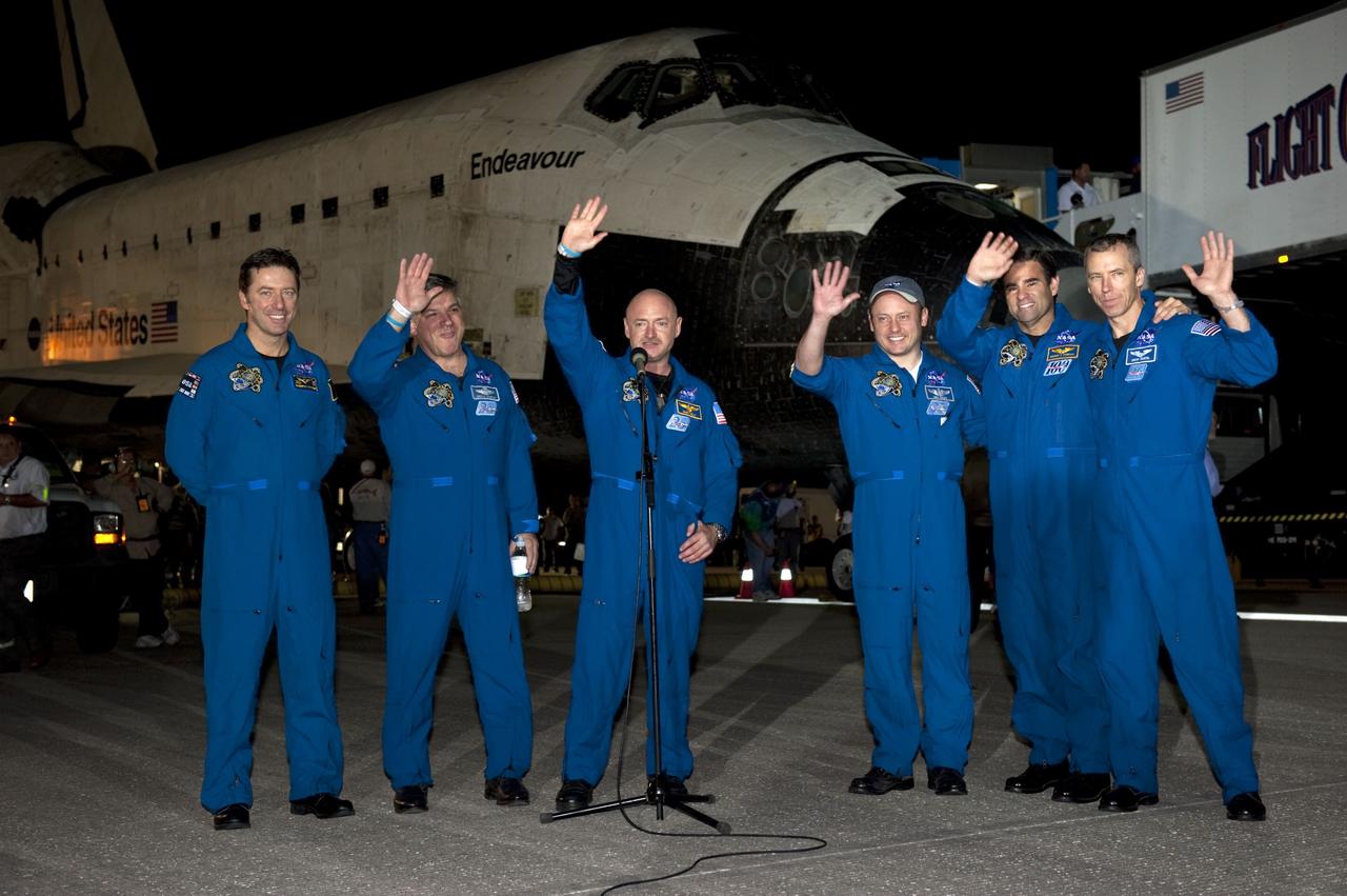 CAPE CANAVERAL, Fla. -- The crew of STS-134 wave to media gathered on the Shuttle Landing Facility at NASA's Kennedy Space Center in Florida following the successful landing of space shuttle Endeavour. From left, are the European Space Agency's Roberto Vittori, Pilot Greg H. Johnson, Commander Mark Kelly, and Mission Specialists Mike Fincke, Greg Chamitoff and Drew Feustel. The crew returned to Earth at 2:35 a.m. EDT on Runway 15, completing a 16-day, 6.5-million mile journey to the International Space Station. STS-134 delivered the Alpha Magnetic Spectrometer-2 (AMS) and the Express Logistics Carrier-3 (ELC-3) to the International Space Station. AMS will help researchers understand the origin of the universe and search for evidence of dark matter, strange matter and antimatter from the station. ELC-3 carried spare parts that will sustain station operations once the shuttles are retired from service. STS-134 was the 25th and final flight for Endeavour, which spent 299 days in space, orbited Earth 4,671 times and traveled 122,883,151 miles. Photo credit: NASA/Kim Shiflett