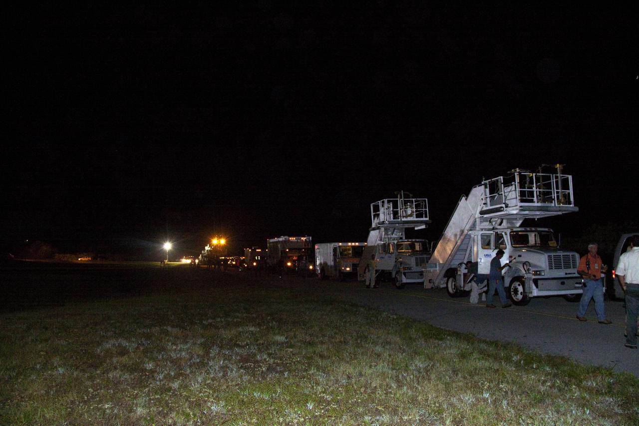 CAPE CANAVERAL, Fla. -- The landing convoy that will make space shuttle Endeavour safe and secure for towing to its processing hangar begins to pull up around the vehicle following wheelstop on the Shuttle Landing Facility's Runway 15 at NASA's Kennedy Space Center in Florida. Endeavour's final return from space completed the 16-day, 6.5-million-mile STS-134 mission. Main gear touchdown was at 2:34:51 a.m. EDT, followed by nose gear touchdown at 2:35:04 a.m., and wheelstop at 2:35:36 a.m.              Endeavour's final return from space completed the 16-day, 6.5-million-mile STS-134 mission. Main gear touchdown was at 2:34:51 a.m. EDT, followed by nose gear touchdown at 2:35:04 a.m., and wheelstop at 2:35:36 a.m.   Endeavour and its crew delivered the Alpha Magnetic Spectrometer-2 (AMS) and the Express Logistics Carrier-3 (ELC-3) to the International Space Station. AMS will help researchers understand the origin of the universe and search for evidence of dark matter, strange matter and antimatter from the station. ELC-3 carried spare parts that will sustain station operations once the shuttles are retired from service. STS-134 was the 25th and final flight for Endeavour, which spent 299 days in space, orbited Earth 4,671 times and traveled 122,883,151 miles. Photo credit: NASA/Jack Pfaller