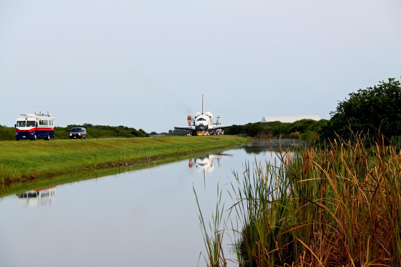 CAPE CANAVERAL, Fla. -- In the early morning hours after landing, space shuttle Endeavour's "towback" vehicle slowly pulls it from the Shuttle Landing Facility to Orbiter Processing Facility-1 at NASA's Kennedy Space Center in Florida. A purge unit that pumps conditioned air into a shuttle after landing is connected to Endeavour's aft end. Once inside the processing facility, Endeavour will be prepared for future public display.          Endeavour's final return from space completed the 16-day, 6.5-million-mile STS-134 mission. Main gear touchdown was at 2:34:51 a.m. EDT, followed by nose gear touchdown at 2:35:04 a.m., and wheelstop at 2:35:36 a.m.   Endeavour and its crew delivered the Alpha Magnetic Spectrometer-2 (AMS) and the Express Logistics Carrier-3 (ELC-3) to the International Space Station. AMS will help researchers understand the origin of the universe and search for evidence of dark matter, strange matter and antimatter from the station. ELC-3 carried spare parts that will sustain station operations once the shuttles are retired from service. STS-134 was the 25th and final flight for Endeavour, which spent 299 days in space, orbited Earth 4,671 times and traveled 122,883,151 miles. Photo credit: NASA/Jack Pfaller