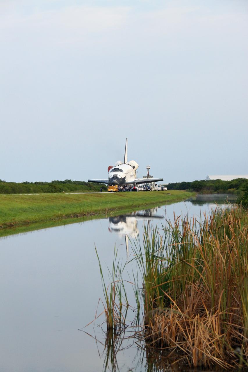 CAPE CANAVERAL, Fla. -- A "towback" vehicle slowly pulls shuttle Endeavour from the Shuttle Landing Facility to Orbiter Processing Facility-1 at NASA's Kennedy Space Center in Florida. A purge unit that pumps conditioned air into a shuttle after landing is connected to Endeavour's aft end. Once inside the processing facility, Endeavour will be prepared for future public display.    Endeavour's final return from space completed the 16-day, 6.5-million-mile STS-134 mission. Main gear touchdown was at 2:34:51 a.m. EDT, followed by nose gear touchdown at 2:35:04 a.m., and wheelstop at 2:35:36 a.m.   Endeavour and its crew delivered the Alpha Magnetic Spectrometer-2 (AMS) and the Express Logistics Carrier-3 (ELC-3) to the International Space Station. AMS will help researchers understand the origin of the universe and search for evidence of dark matter, strange matter and antimatter from the station. ELC-3 carried spare parts that will sustain station operations once the shuttles are retired from service. STS-134 was the 25th and final flight for Endeavour, which spent 299 days in space, orbited Earth 4,671 times and traveled 122,883,151 miles. Photo credit: NASA/Jack Pfaller