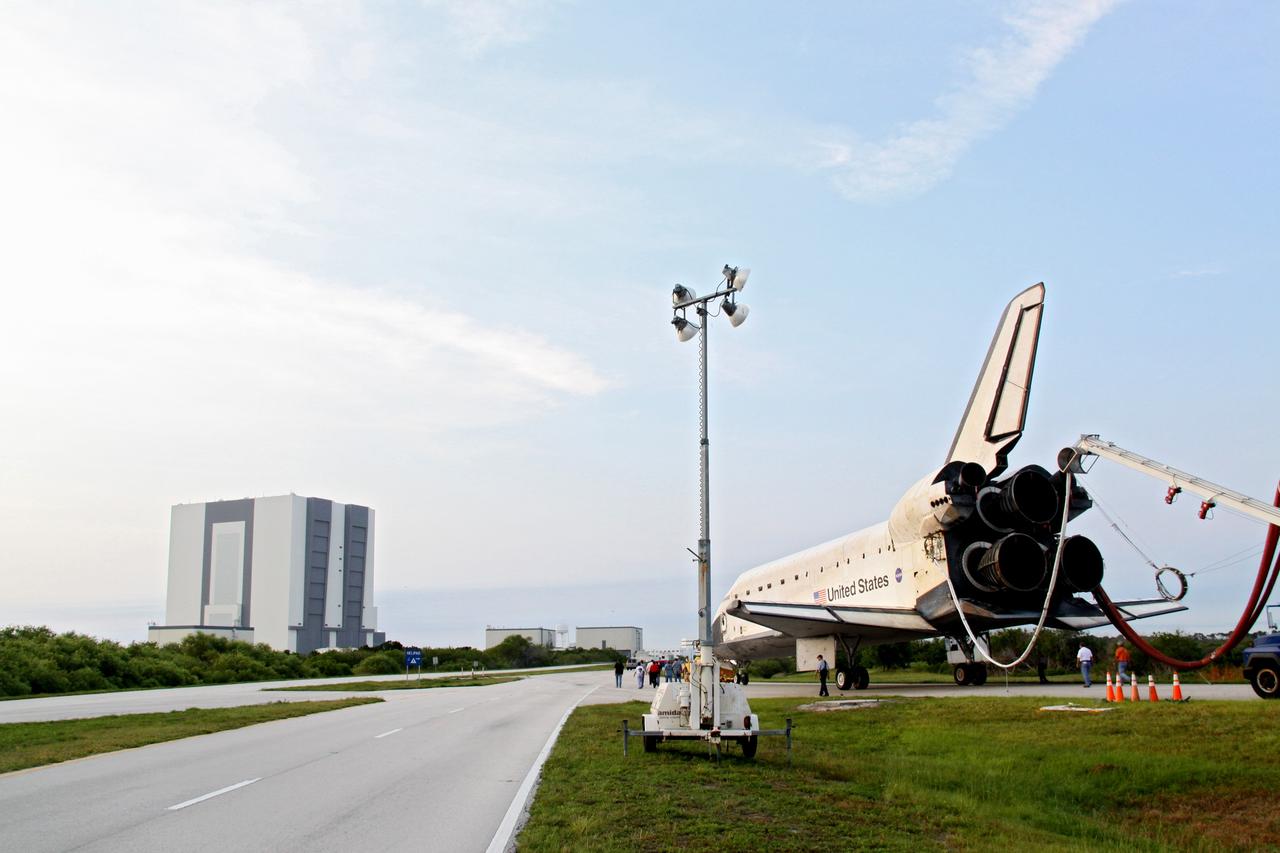 CAPE CANAVERAL, Fla. -- A "towback" vehicle slowly pulls shuttle Endeavour from the Shuttle Landing Facility to Orbiter Processing Facility-1 at NASA's Kennedy Space Center in Florida. A purge unit that pumps conditioned air into a shuttle after landing is connected to Endeavour's aft end. In the background is the massive Vehicle Assembly Building. Once inside the processing facility, Endeavour will be prepared for future public display.              Endeavour's final return from space completed the 16-day, 6.5-million-mile STS-134 mission. Main gear touchdown was at 2:34:51 a.m. EDT, followed by nose gear touchdown at 2:35:04 a.m., and wheelstop at 2:35:36 a.m.   Endeavour and its crew delivered the Alpha Magnetic Spectrometer-2 (AMS) and the Express Logistics Carrier-3 (ELC-3) to the International Space Station. AMS will help researchers understand the origin of the universe and search for evidence of dark matter, strange matter and antimatter from the station. ELC-3 carried spare parts that will sustain station operations once the shuttles are retired from service. STS-134 was the 25th and final flight for Endeavour, which spent 299 days in space, orbited Earth 4,671 times and traveled 122,883,151 miles. Photo credit: NASA/Jack Pfaller