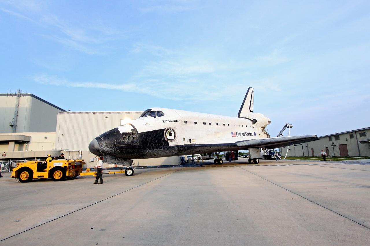 CAPE CANAVERAL, Fla. -- A "towback" vehicle slowly pulls shuttle Endeavour into Orbiter Processing Facility-1 at NASA's Kennedy Space Center in Florida. A purge unit that pumps conditioned air into a shuttle after landing is connected to Endeavour's aft end. Once inside the processing facility, Endeavour will be prepared for future public display.              Endeavour's final return from space completed the 16-day, 6.5-million-mile STS-134 mission. Main gear touchdown was at 2:34:51 a.m. EDT, followed by nose gear touchdown at 2:35:04 a.m., and wheelstop at 2:35:36 a.m.   Endeavour and its crew delivered the Alpha Magnetic Spectrometer-2 (AMS) and the Express Logistics Carrier-3 (ELC-3) to the International Space Station. AMS will help researchers understand the origin of the universe and search for evidence of dark matter, strange matter and antimatter from the station. ELC-3 carried spare parts that will sustain station operations once the shuttles are retired from service. STS-134 was the 25th and final flight for Endeavour, which spent 299 days in space, orbited Earth 4,671 times and traveled 122,883,151 miles. Photo credit: NASA/Jack Pfaller