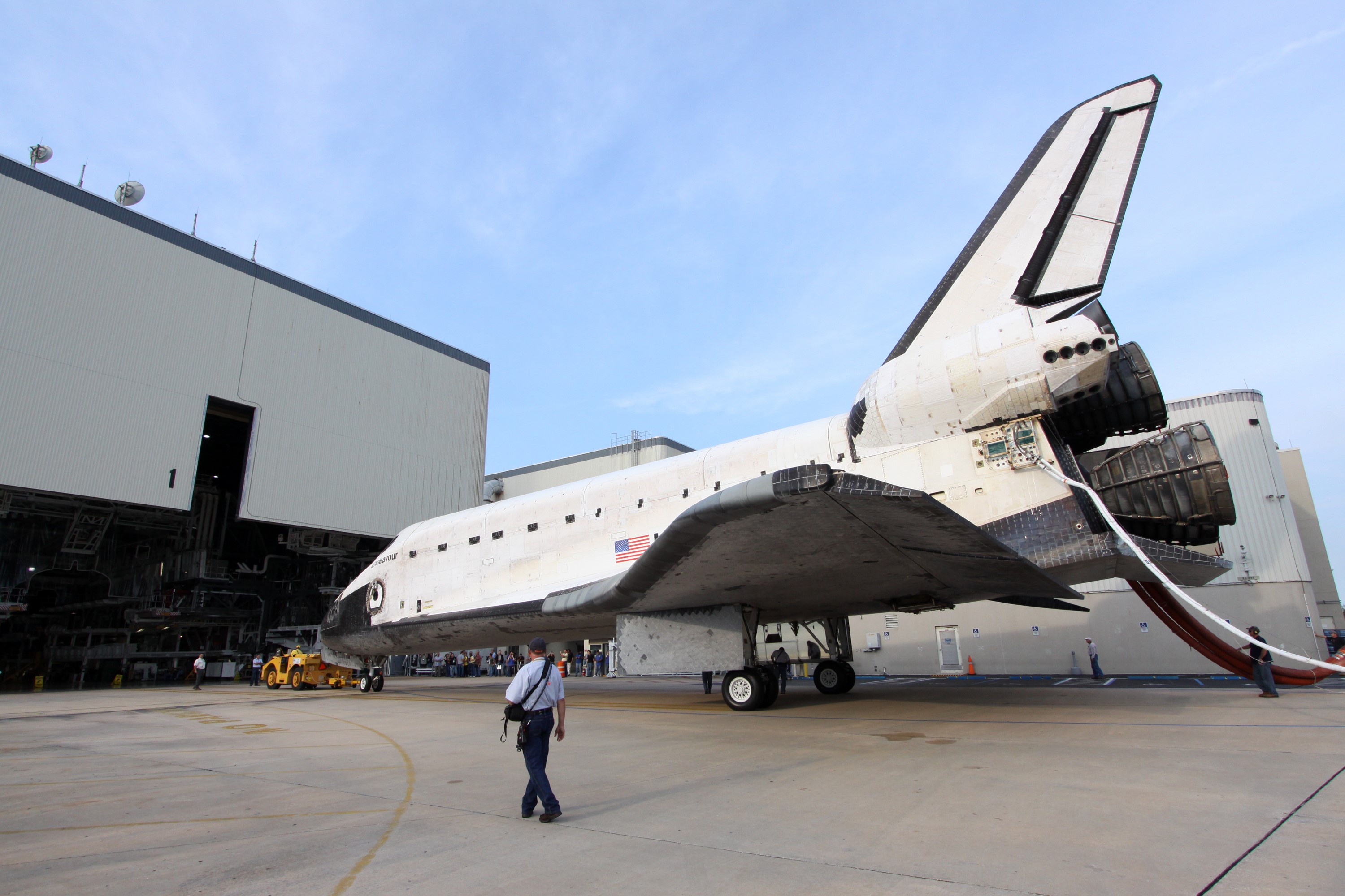 CAPE CANAVERAL, Fla. -- A "towback" vehicle slowly pulls shuttle Endeavour into Orbiter Processing Facility-1 at NASA's Kennedy Space Center in Florida. A purge unit that pumps conditioned air into a shuttle after landing is connected to Endeavour's aft end. Once inside the processing facility, Endeavour will be prepared for future public display.              Endeavour's final return from space completed the 16-day, 6.5-million-mile STS-134 mission. Main gear touchdown was at 2:34:51 a.m. EDT, followed by nose gear touchdown at 2:35:04 a.m., and wheelstop at 2:35:36 a.m.   Endeavour and its crew delivered the Alpha Magnetic Spectrometer-2 (AMS) and the Express Logistics Carrier-3 (ELC-3) to the International Space Station. AMS will help researchers understand the origin of the universe and search for evidence of dark matter, strange matter and antimatter from the station. ELC-3 carried spare parts that will sustain station operations once the shuttles are retired from service. STS-134 was the 25th and final flight for Endeavour, which spent 299 days in space, orbited Earth 4,671 times and traveled 122,883,151 miles. Photo credit: NASA/Jack Pfaller