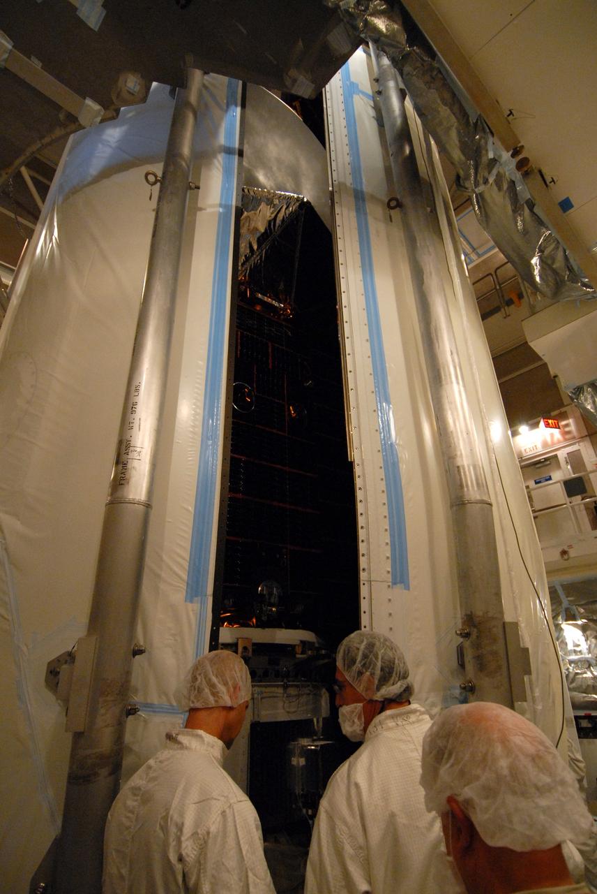 VANDENBERG AIR FORCE BASE, Calif. -- Inside the mobile service tower at NASA's Launch Complex-2 at Vandenberg Air Force Base in California, workers monitor the progress as the United Launch Alliance’s Delta II payload fairing closes around the Aquarius/SAC-D spacecraft. Aquarius will be integrated to the Delta II rocket in preparation for the targeted June 9 liftoff. Aquarius, the NASA-built instrument on the SAC-D spacecraft, will provide new insights into how variations in ocean surface salinity relate to fundamental climate processes on its three-year mission. Photo credit: NASA/VAFB