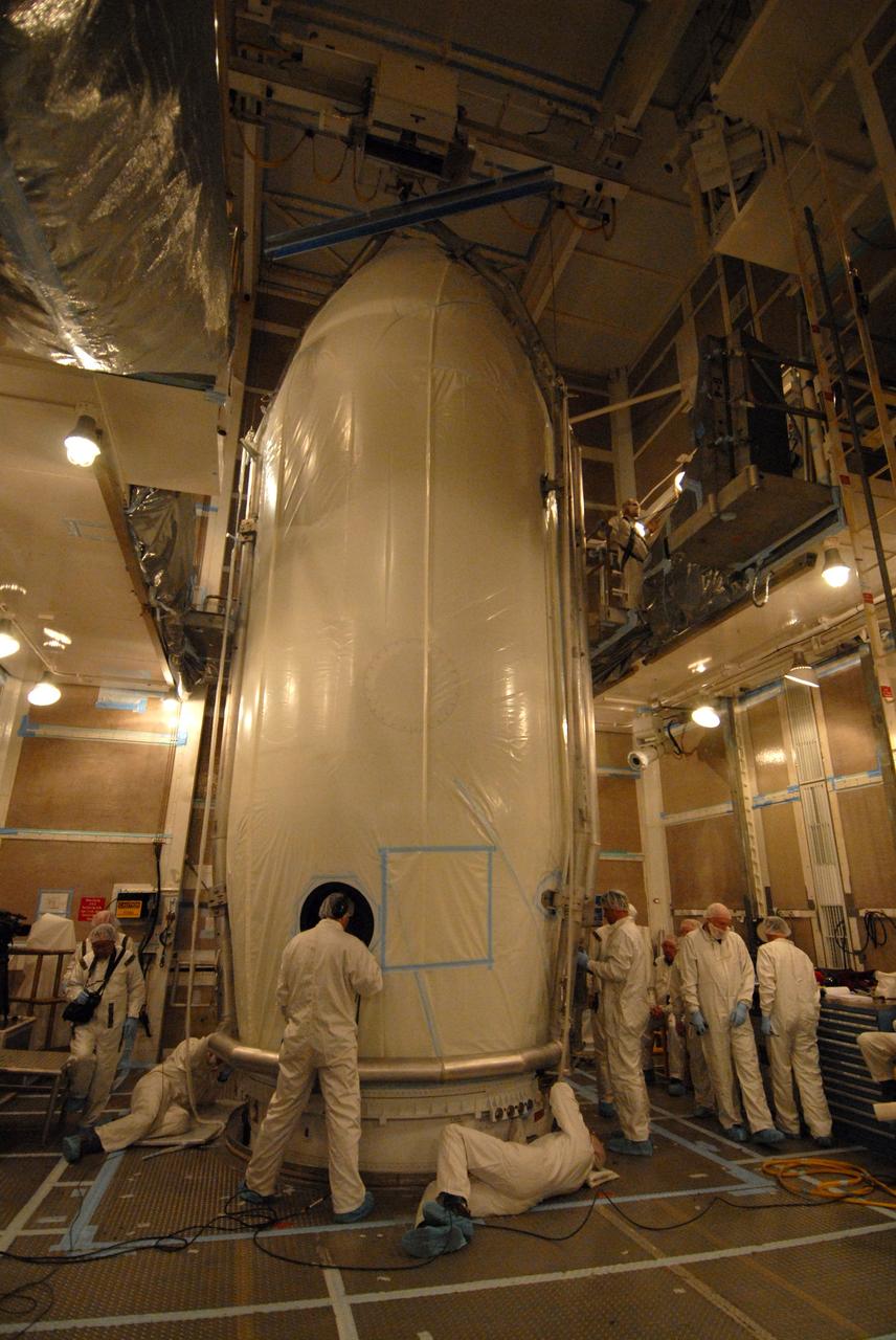 VANDENBERG AIR FORCE BASE, Calif. -- Inside the mobile service tower at NASA's Launch Complex-2 at Vandenberg Air Force Base in California, technicians secure the United Launch Alliance’s Delta II payload fairing around the Aquarius/SAC-D spacecraft. Aquarius will be integrated to the Delta II rocket in preparation for the targeted June 9 liftoff. Aquarius, the NASA-built instrument on the SAC-D spacecraft, will provide new insights into how variations in ocean surface salinity relate to fundamental climate processes on its three-year mission. Photo credit: NASA/VAFB