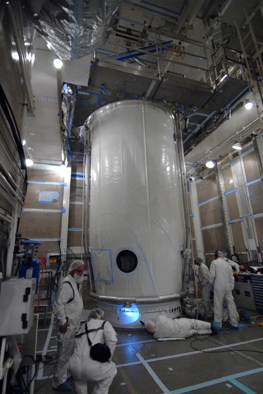 VANDENBERG AIR FORCE BASE, Calif. -- Inside the mobile service tower at NASA's Launch Complex-2 at Vandenberg Air Force Base in California, workers secure the United Launch Alliance’s Delta II payload fairing around the Aquarius/SAC-D spacecraft. Aquarius will be integrated to the Delta II rocket in preparation for the targeted June 9 liftoff. Aquarius, the NASA-built instrument on the SAC-D spacecraft, will provide new insights into how variations in ocean surface salinity relate to fundamental climate processes on its three-year mission. Photo credit: NASA/VAFB