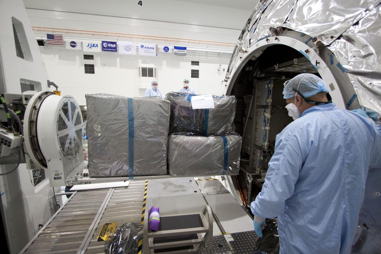 CAPE CANAVERAL, Fla. -- In the Space Station Processing Facility at NASA's Kennedy Space Center in Florida, technicians garbed in protective wear, commonly known as 'bunny suits,' install cargo inside the Raffaello multi-purpose logistics module for shuttle Atlantis' flight to the International Space Station. Commander Chris Ferguson, Pilot Doug Hurley and Mission Specialists Sandra Magnus and Rex Walheim are targeted to lift off on July 8, taking with them the Raffaello multi-purpose logistics module packed with supplies, logistics and spare parts. The STS-135 mission also will fly a system to investigate the potential for robotically refueling existing spacecraft and return a failed ammonia pump module to help NASA better understand the failure mechanism and improve pump designs for future systems. STS-135 will be the 33rd flight of Atlantis, the 37th shuttle mission to the space station, and the 135th and final mission of NASA's Space Shuttle Program. For more information visit, www.nasa.gov/mission_pages/shuttle/shuttlemissions/sts135/index.html. Photo credit: NASA/Jack Pfaller