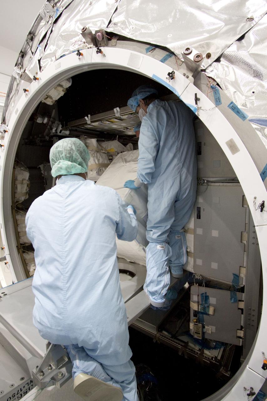 CAPE CANAVERAL, Fla. -- In the Space Station Processing Facility at NASA's Kennedy Space Center in Florida, technicians garbed in protective wear, commonly known as 'bunny suits,' install cargo inside the Raffaello multi-purpose logistics module for shuttle Atlantis' flight to the International Space Station. Commander Chris Ferguson, Pilot Doug Hurley and Mission Specialists Sandra Magnus and Rex Walheim are targeted to lift off on July 8, taking with them the Raffaello multi-purpose logistics module packed with supplies, logistics and spare parts. The STS-135 mission also will fly a system to investigate the potential for robotically refueling existing spacecraft and return a failed ammonia pump module to help NASA better understand the failure mechanism and improve pump designs for future systems. STS-135 will be the 33rd flight of Atlantis, the 37th shuttle mission to the space station, and the 135th and final mission of NASA's Space Shuttle Program. For more information visit, www.nasa.gov/mission_pages/shuttle/shuttlemissions/sts135/index.html. Photo credit: NASA/Jack Pfaller