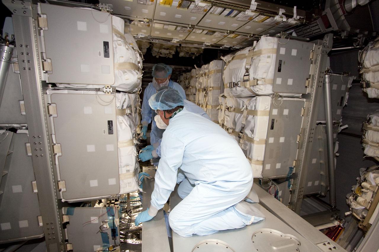 CAPE CANAVERAL, Fla. -- In the Space Station Processing Facility at NASA's Kennedy Space Center in Florida, technicians garbed in protective wear, commonly known as 'bunny suits,' install cargo inside the Raffaello multi-purpose logistics module for shuttle Atlantis' flight to the International Space Station. Commander Chris Ferguson, Pilot Doug Hurley and Mission Specialists Sandra Magnus and Rex Walheim are targeted to lift off on July 8, taking with them the Raffaello multi-purpose logistics module packed with supplies, logistics and spare parts. The STS-135 mission also will fly a system to investigate the potential for robotically refueling existing spacecraft and return a failed ammonia pump module to help NASA better understand the failure mechanism and improve pump designs for future systems. STS-135 will be the 33rd flight of Atlantis, the 37th shuttle mission to the space station, and the 135th and final mission of NASA's Space Shuttle Program. For more information visit, www.nasa.gov/mission_pages/shuttle/shuttlemissions/sts135/index.html. Photo credit: NASA/Jack Pfaller