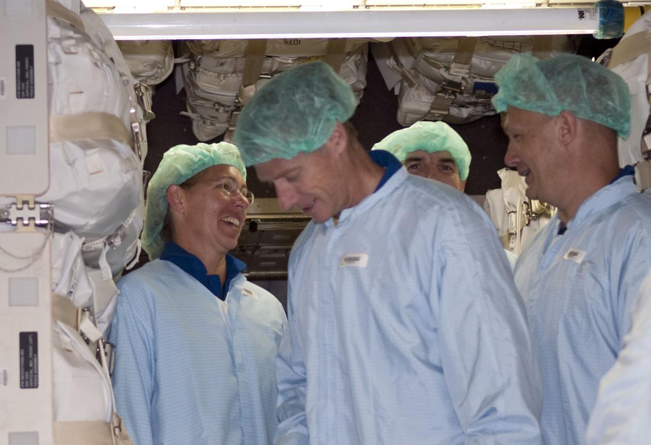 CAPE CANAVERAL, Fla. -- Space shuttle Atlantis' STS-135 crew participates in a crew equipment interface test, or CEIT, in the Space Station Processing Facility at NASA's Kennedy Space Center in Florida. Standing inside the Raffaello multi-purpose logistics module, which will be packed with supplies, logistics and spare parts for their mission to the International Space Station, are Mission Specialist Sandy Magnus (left), Commander Chris Ferguson, Mission Specialist Rex Walheim and Pilot Doug Hurley.      The purpose of CEIT is for flight crew members to become familiar with the payload they will be working with and delivering to the station. STS-135 also will return a failed ammonia pump module on the Lightweight Multi-Purpose Experiment Support Structure Carrier, or LMC, to help NASA better understand the failure mechanism and improve pump designs for future systems. STS-135, targeted to launch June 28, will be the 33rd flight of Atlantis, the 37th shuttle mission to the space station, and the 135th and final mission of NASA's Space Shuttle Program. For more information visit, www.nasa.gov/mission_pages/shuttle/shuttlemissions/sts135/index.html. Photo credit: NASA/Jim Grossmann