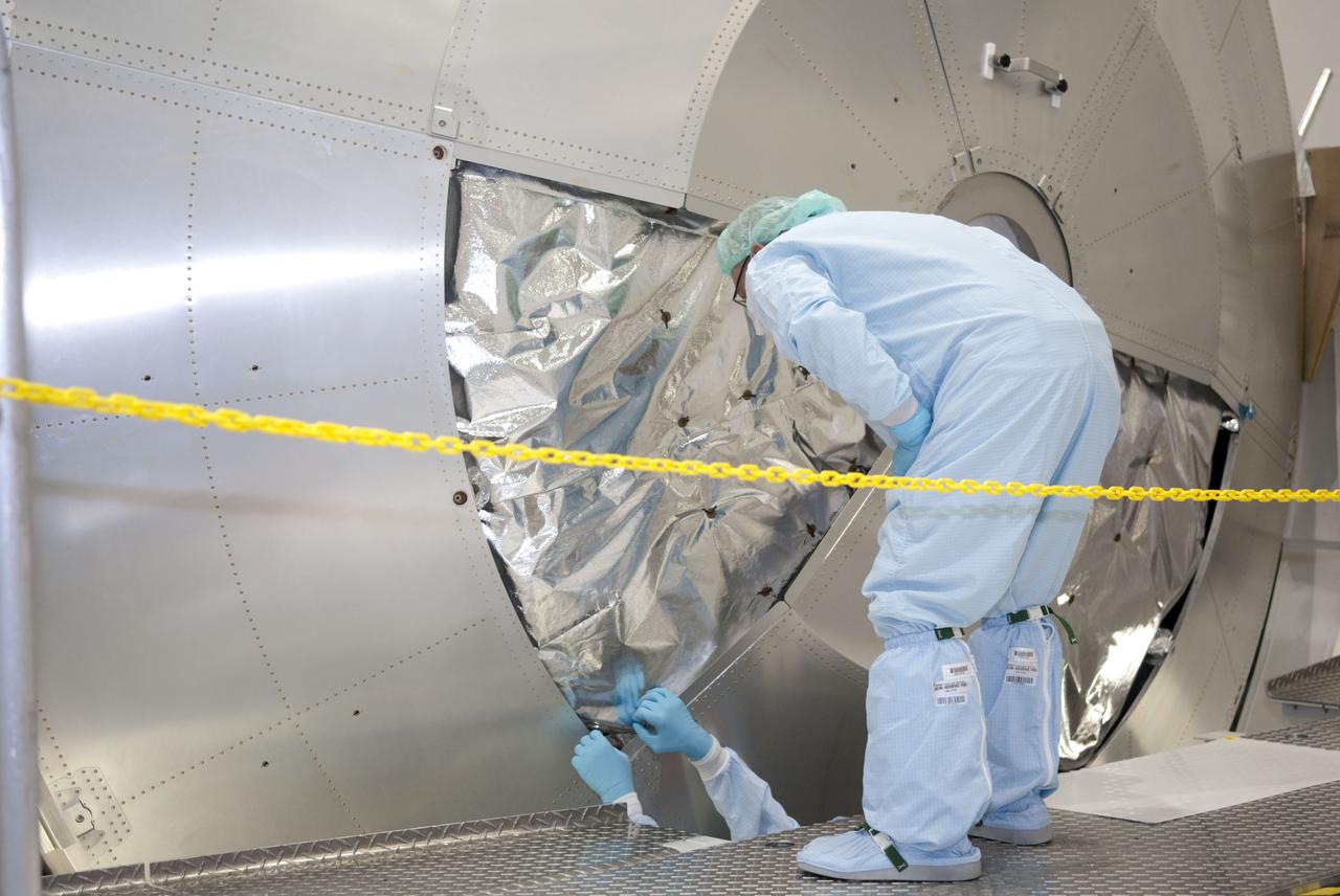 CAPE CANAVERAL, Fla. -- In the Space Station Processing Facility at NASA's Kennedy Space Center in Florida, technicians are installing a debris shield over the aft hatch on the Raffaello multi-purpose logistics module for shuttle Atlantis' flight to the International Space Station.      Commander Chris Ferguson, Pilot Doug Hurley and Mission Specialists Sandra Magnus and Rex Walheim are targeted to lift off on July 8, taking with them the Raffaello multi-purpose logistics module packed with supplies, logistics and spare parts. The STS-135 mission also will fly a system to investigate the potential for robotically refueling existing spacecraft and return a failed ammonia pump module to help NASA better understand the failure mechanism and improve pump designs for future systems. STS-135 will be the 33rd flight of Atlantis, the 37th shuttle mission to the space station, and the 135th and final mission of NASA's Space Shuttle Program. For more information visit, www.nasa.gov/mission_pages/shuttle/shuttlemissions/sts135/index.html. Photo credit: NASA/Jim Grossmann