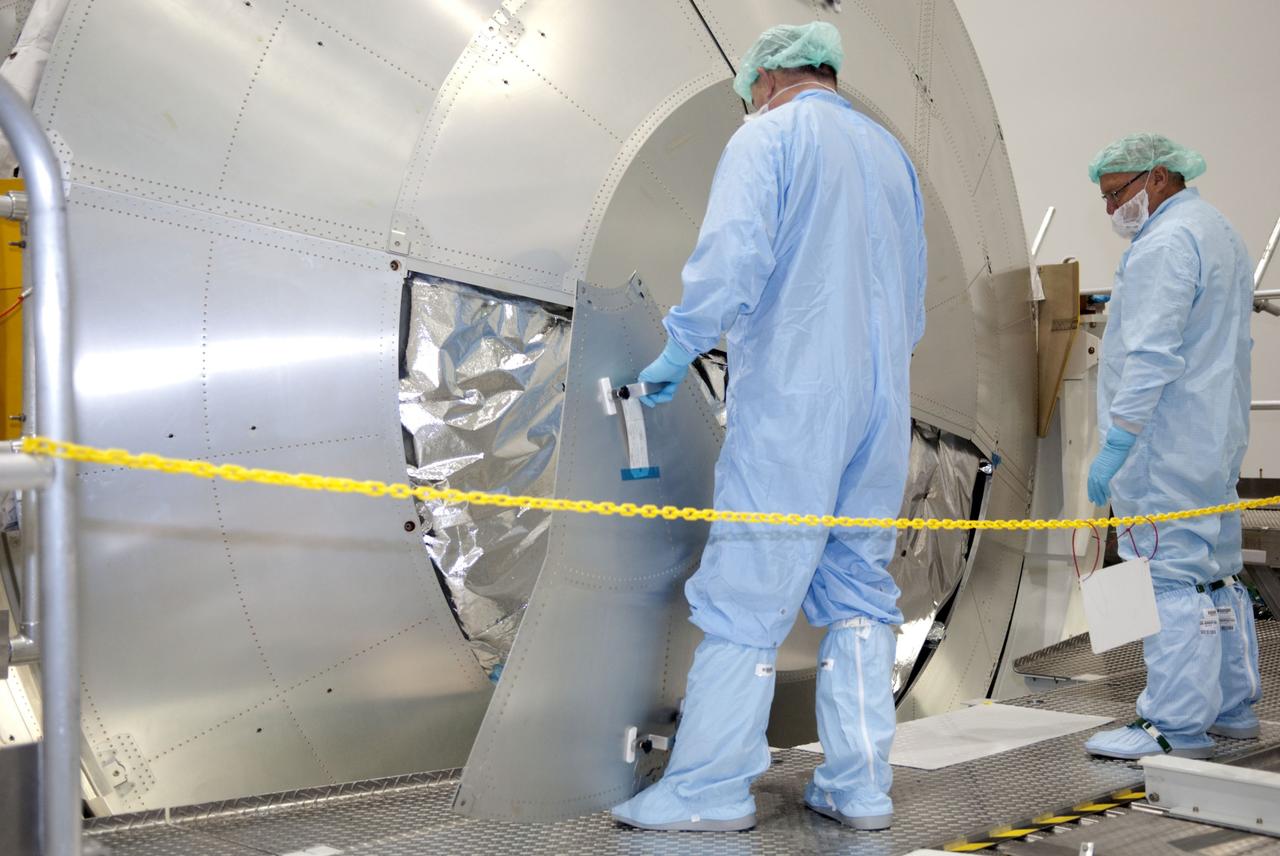 CAPE CANAVERAL, Fla. -- In the Space Station Processing Facility at NASA's Kennedy Space Center in Florida, technicians are installing a debris shield over the aft hatch on the Raffaello multi-purpose logistics module for shuttle Atlantis' flight to the International Space Station.      Commander Chris Ferguson, Pilot Doug Hurley and Mission Specialists Sandra Magnus and Rex Walheim are targeted to lift off on July 8, taking with them the Raffaello multi-purpose logistics module packed with supplies, logistics and spare parts. The STS-135 mission also will fly a system to investigate the potential for robotically refueling existing spacecraft and return a failed ammonia pump module to help NASA better understand the failure mechanism and improve pump designs for future systems. STS-135 will be the 33rd flight of Atlantis, the 37th shuttle mission to the space station, and the 135th and final mission of NASA's Space Shuttle Program. For more information visit, www.nasa.gov/mission_pages/shuttle/shuttlemissions/sts135/index.html. Photo credit: NASA/Jim Grossmann