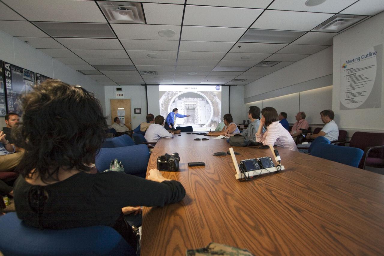 CAPE CANAVERAL, Fla. -- In the Space Station Processing Facility conference room at NASA's Kennedy Space Center in Florida, Mike Kinslow, STS-135 Payload Flow Manager from Boeing Space Operations describes the payload being prepared for shuttle Atlantis' flight to the International Space Station. Commander Chris Ferguson, Pilot Doug Hurley and Mission Specialists Sandra Magnus and Rex Walheim are targeted to lift off on July 8, taking with them the Raffaello multi-purpose logistics module packed with supplies, logistics and spare parts. The STS-135 mission also will fly a system to investigate the potential for robotically refueling existing spacecraft and return a failed ammonia pump module to help NASA better understand the failure mechanism and improve pump designs for future systems. STS-135 will be the 33rd flight of Atlantis, the 37th shuttle mission to the space station, and the 135th and final mission of NASA's Space Shuttle Program. For more information visit, www.nasa.gov/mission_pages/shuttle/shuttlemissions/sts135/index.html. Photo credit: NASA/Jack Pfaller