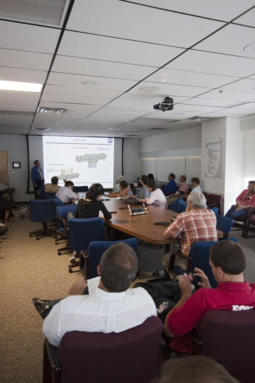CAPE CANAVERAL, Fla. -- In the Space Station Processing Facility conference room at NASA's Kennedy Space Center in Florida, Mike Kinslow, STS-135 Payload Flow Manager from Boeing Space Operations describes the payload being prepared for shuttle Atlantis' flight to the International Space Station. Commander Chris Ferguson, Pilot Doug Hurley and Mission Specialists Sandra Magnus and Rex Walheim are targeted to lift off on July 8, taking with them the Raffaello multi-purpose logistics module packed with supplies, logistics and spare parts. The STS-135 mission also will fly a system to investigate the potential for robotically refueling existing spacecraft and return a failed ammonia pump module to help NASA better understand the failure mechanism and improve pump designs for future systems. STS-135 will be the 33rd flight of Atlantis, the 37th shuttle mission to the space station, and the 135th and final mission of NASA's Space Shuttle Program. For more information visit, www.nasa.gov/mission_pages/shuttle/shuttlemissions/sts135/index.html. Photo credit: NASA/Jack Pfaller